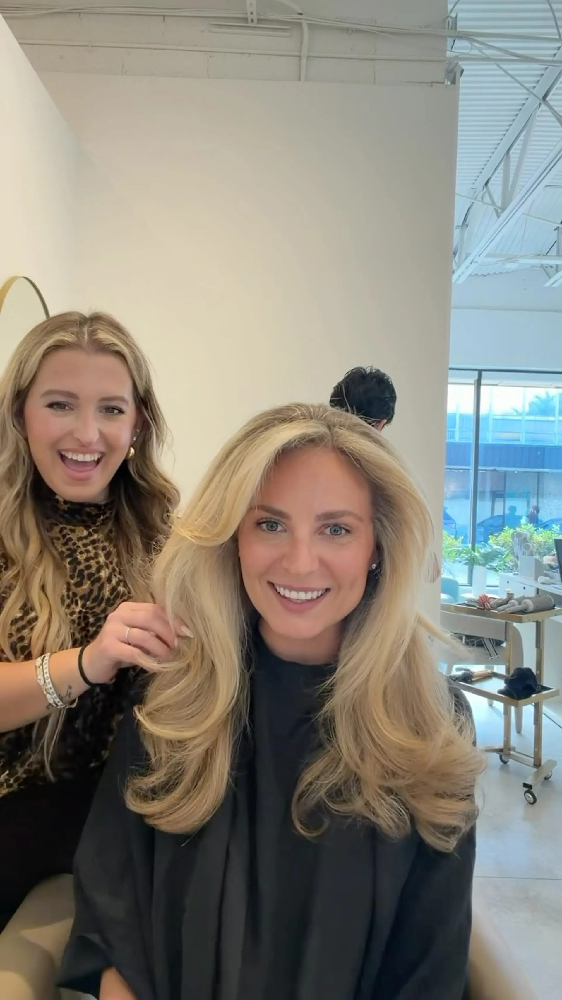 A voluminous blonde blowout with soft face-framing layers and rounded, bouncy ends. 1