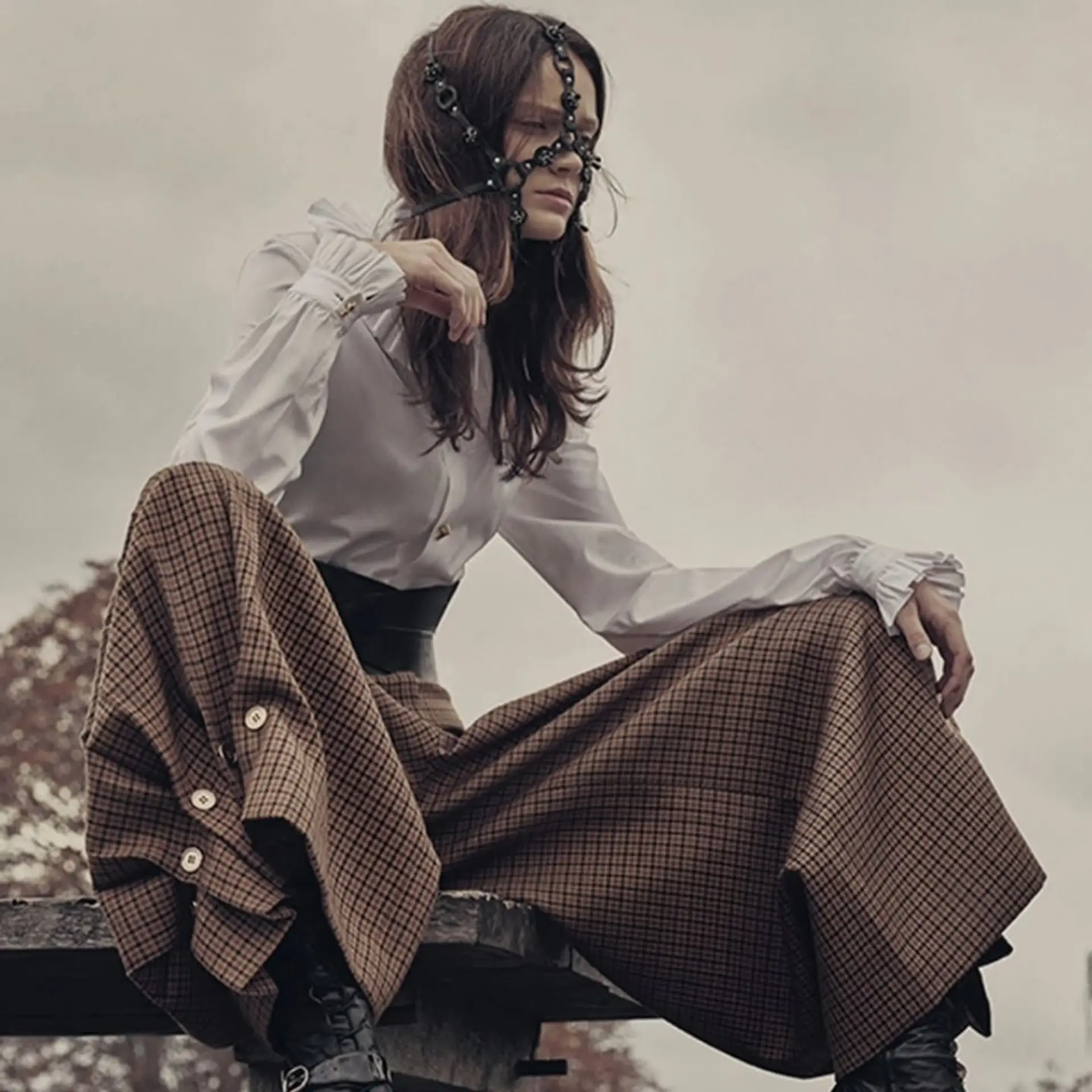 Long dark brown hair styled with natural, tousled waves falling over the shoulders. 1