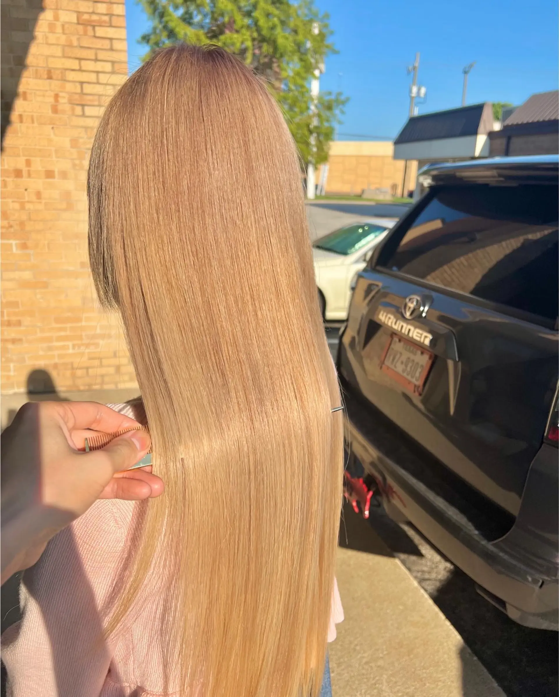 Ultra-sleek and glossy long warm blonde hair styled pin-straight. 1