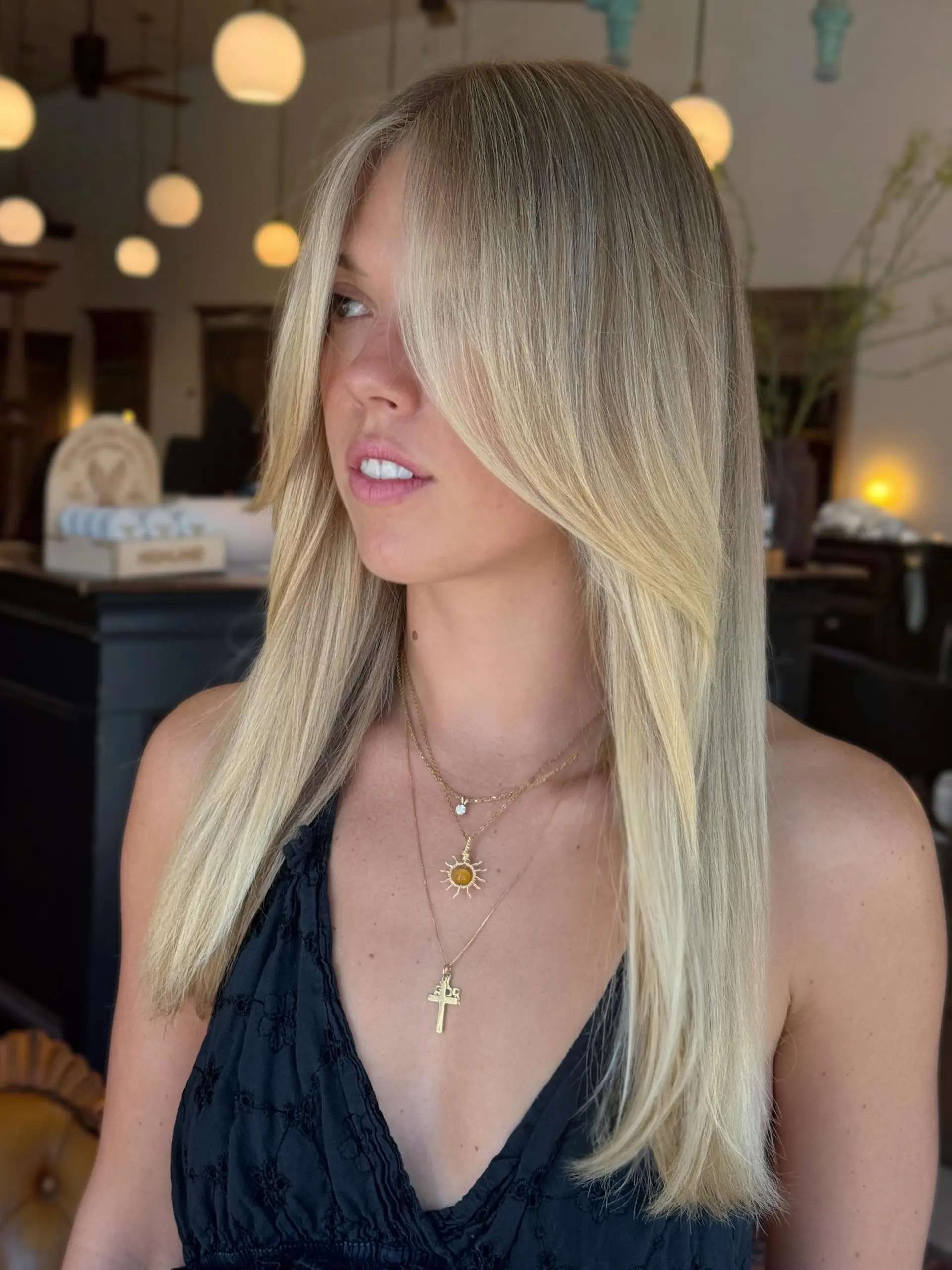 Long, sleek blonde hair with bright dimensional lightening and softly contoured face-framing layers. 1