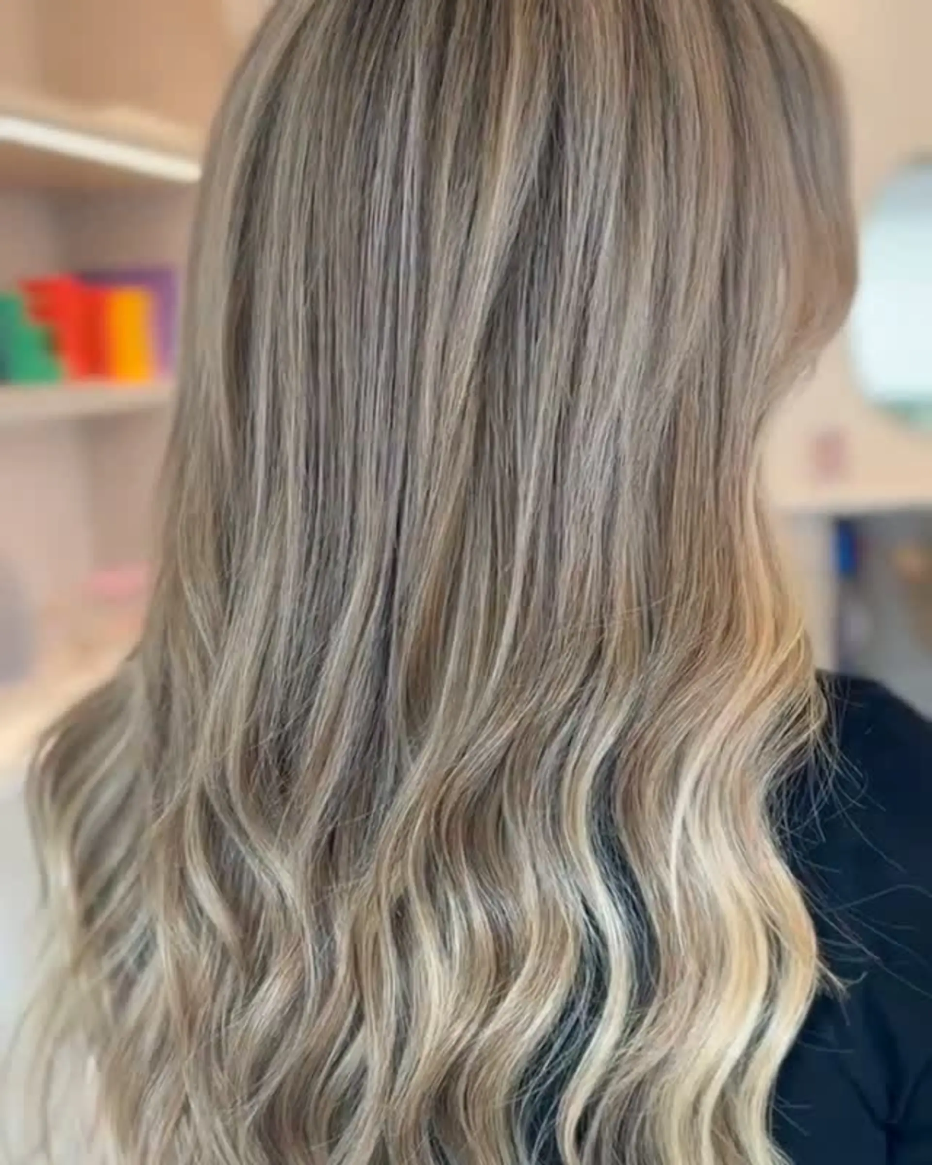 Long hair featuring seamless cool beige and ash blonde highlights styled into loose, gentle waves. 1