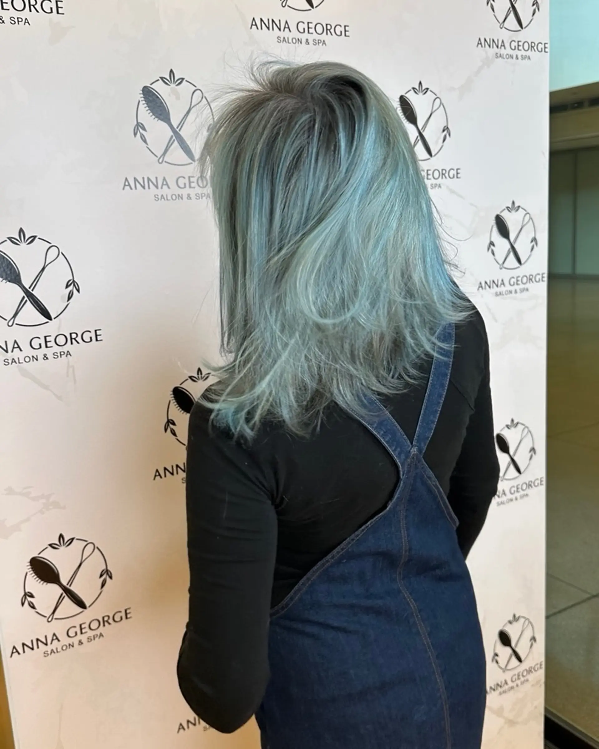 Medium-length textured layered haircut featuring an ethereal pastel icy blue fantasy shade with cool undertones and a softly feathered finish. 1