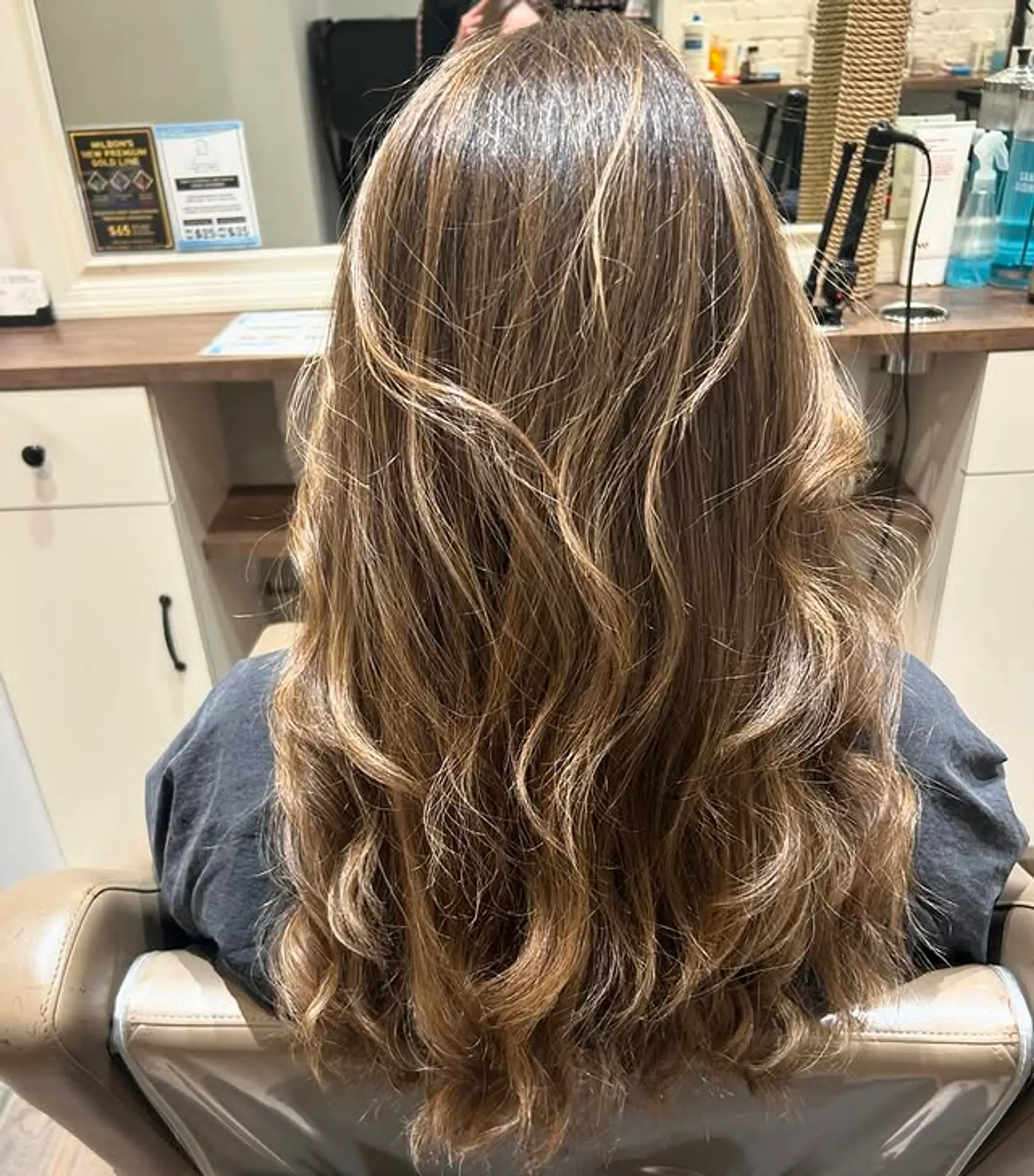Long layered waves with a seamless blend from brown to blonde hues. 1