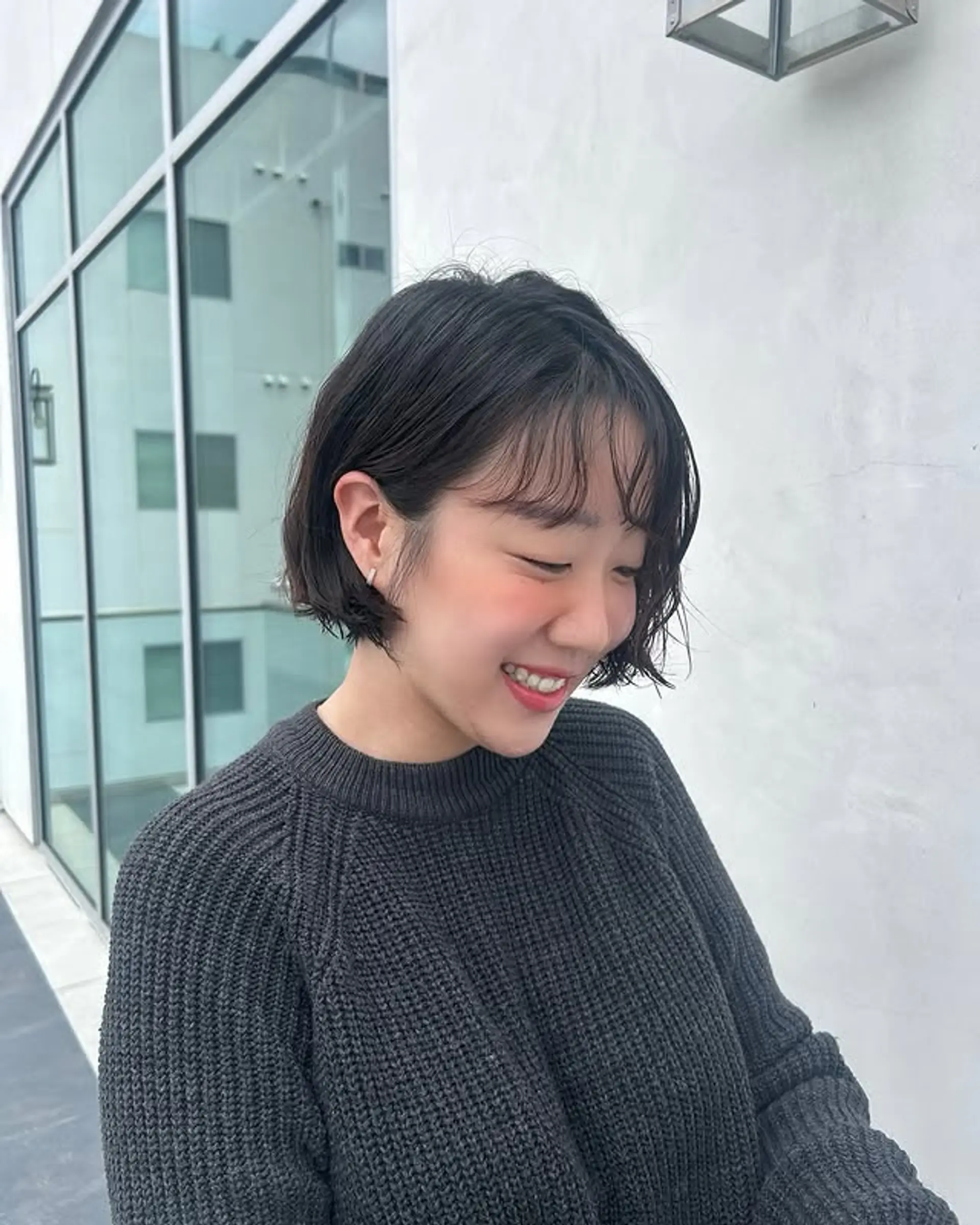 A short, textured French bob with wispy bangs. 1