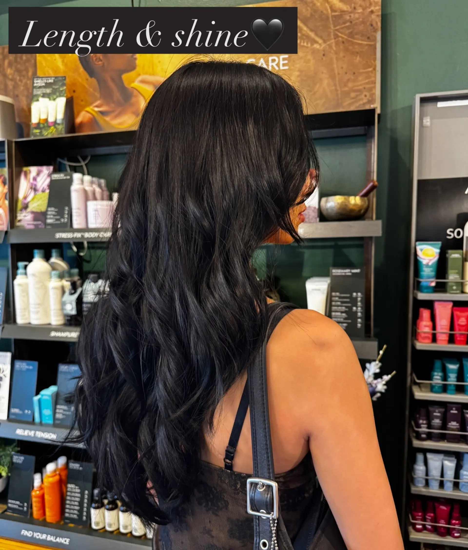 Long, glossy black hair styled into voluminous, soft textured waves. 1