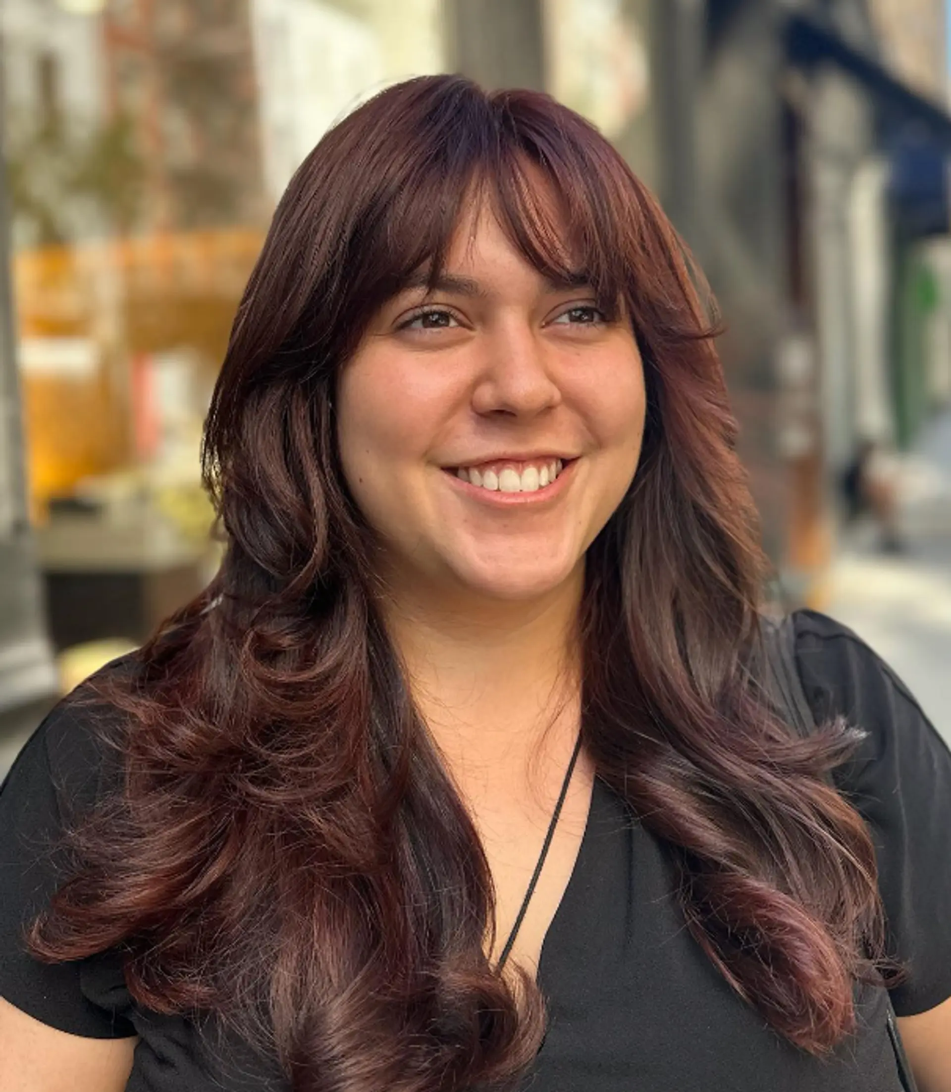 Long, wavy hair with a rich auburn and chestnut color, featuring soft layers and fringe bangs. The hairstyle has natural shine and volume with subtle waves.

Color by @simabeautynyc
Cut and style by @juliamannino_hair
 1