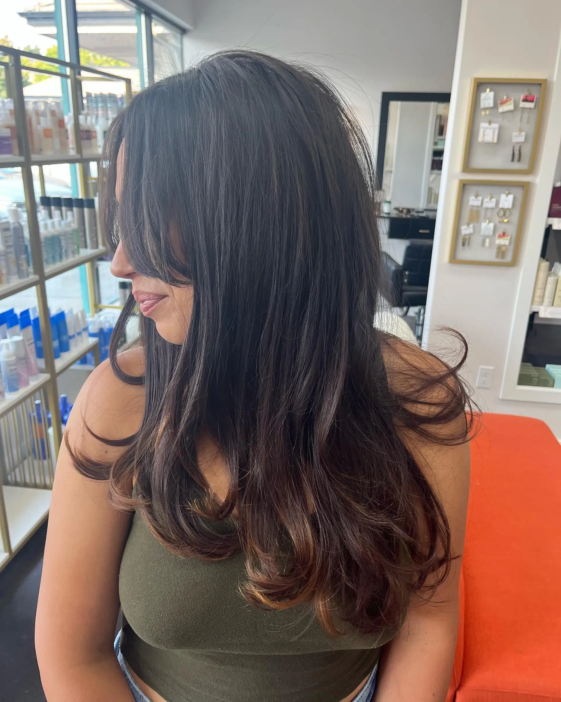 Voluminous long layered blowout with face-framing curtain bangs and flipped ends. 1