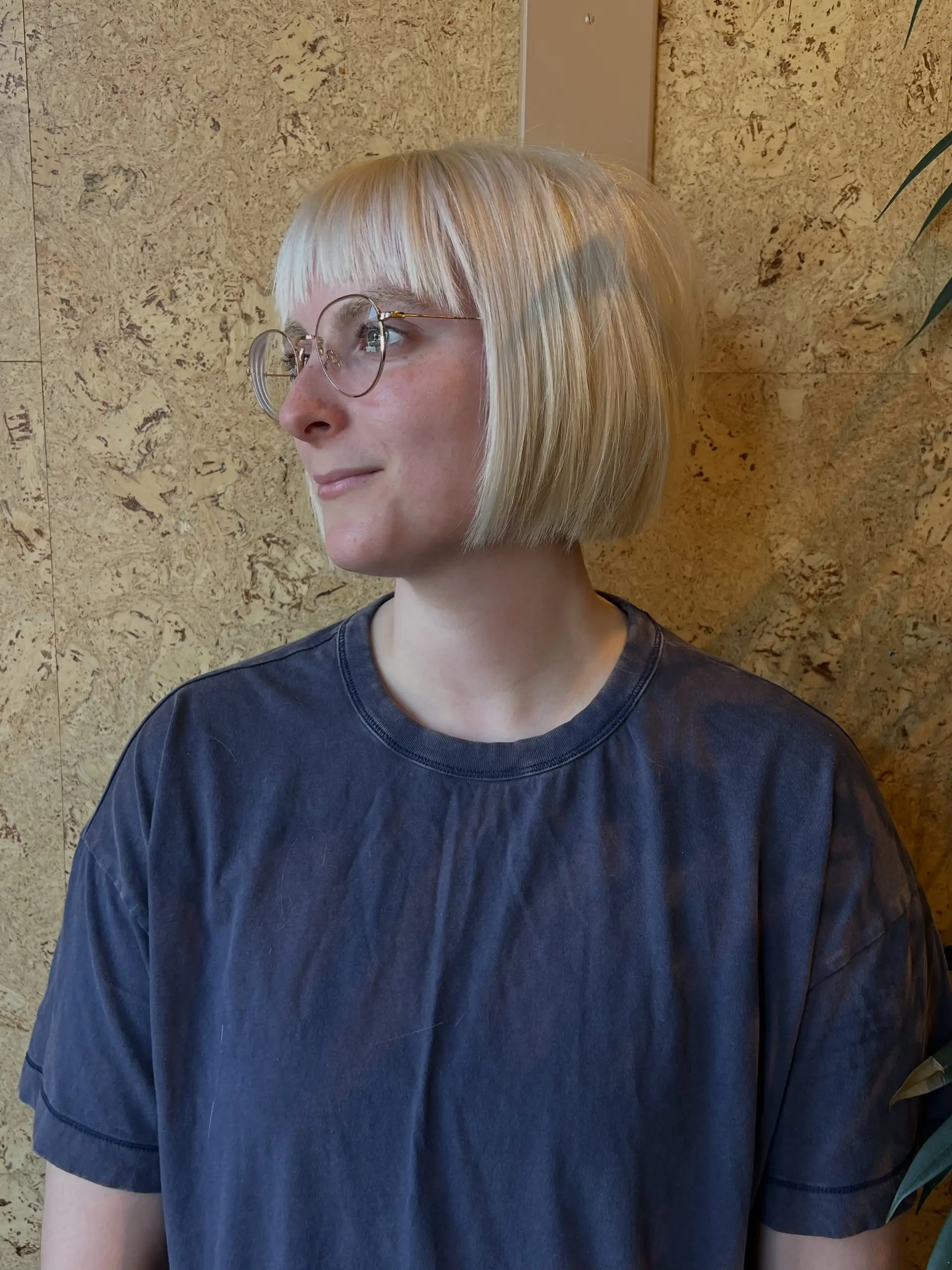 Sleek short platinum blonde blunt bob with straight bangs. 1