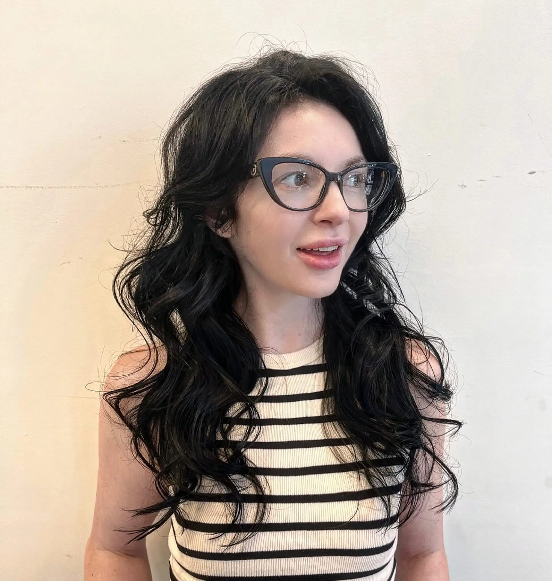 Long, layered wavy hair with a soft, textured finish. 1