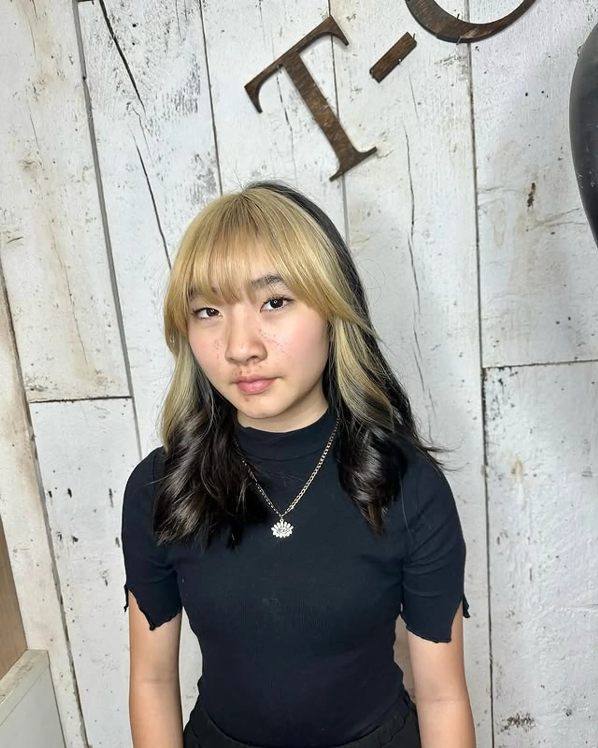 A trendy split dye hairstyle featuring curtain bangs. 1