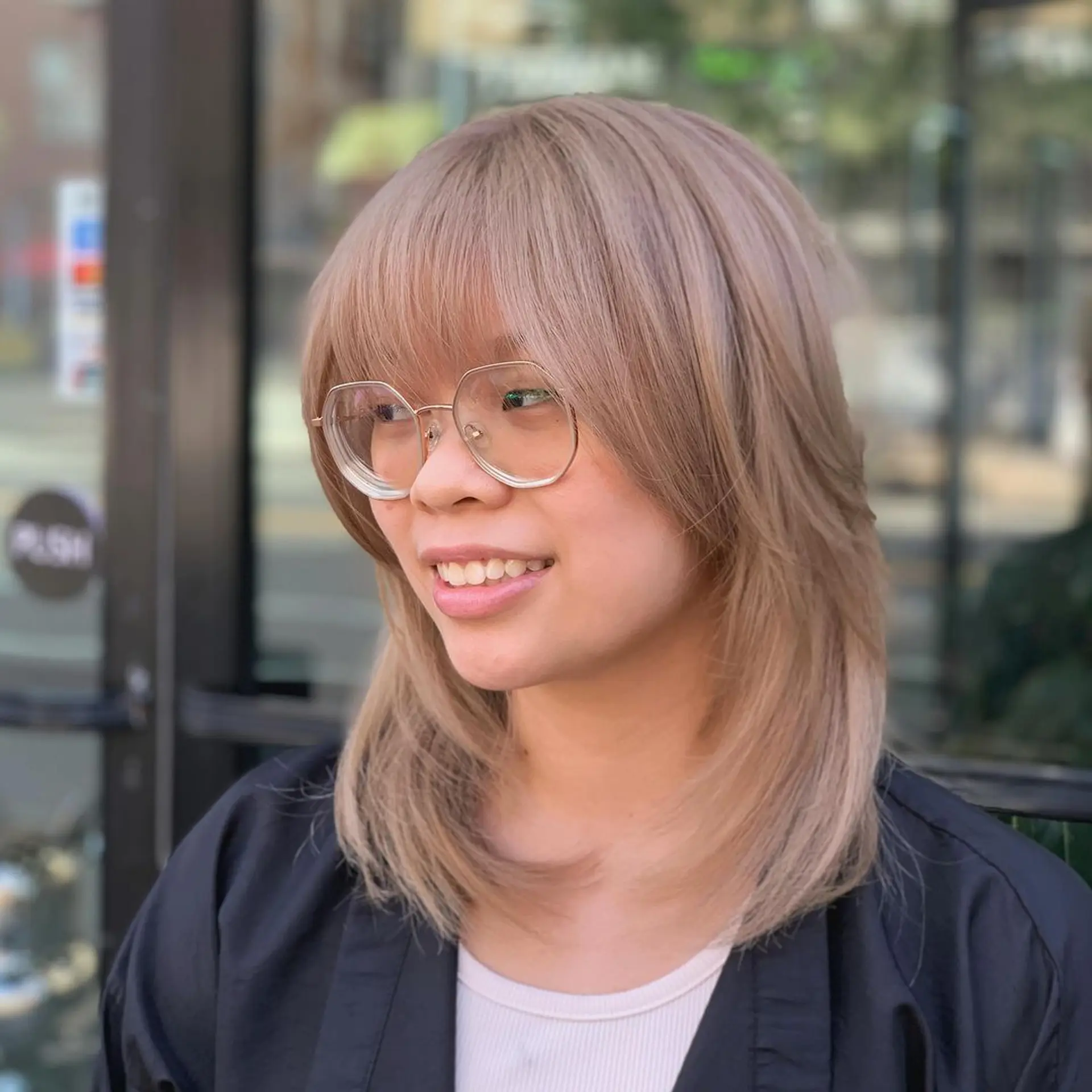 Medium-length ash blonde hair with layers that create a feathered, light appearance. Side-swept bangs frame the face, adding a youthful and trendy look. The hair is straight with a natural shine and sleekness.
Stylist - @xcellent_jason 1
