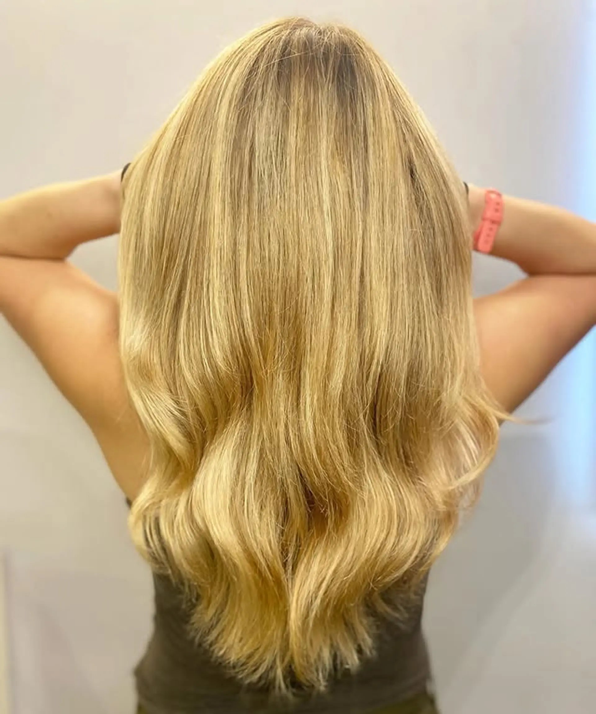 A long layered hairstyle with wavy ends and sun-kissed highlights. 1