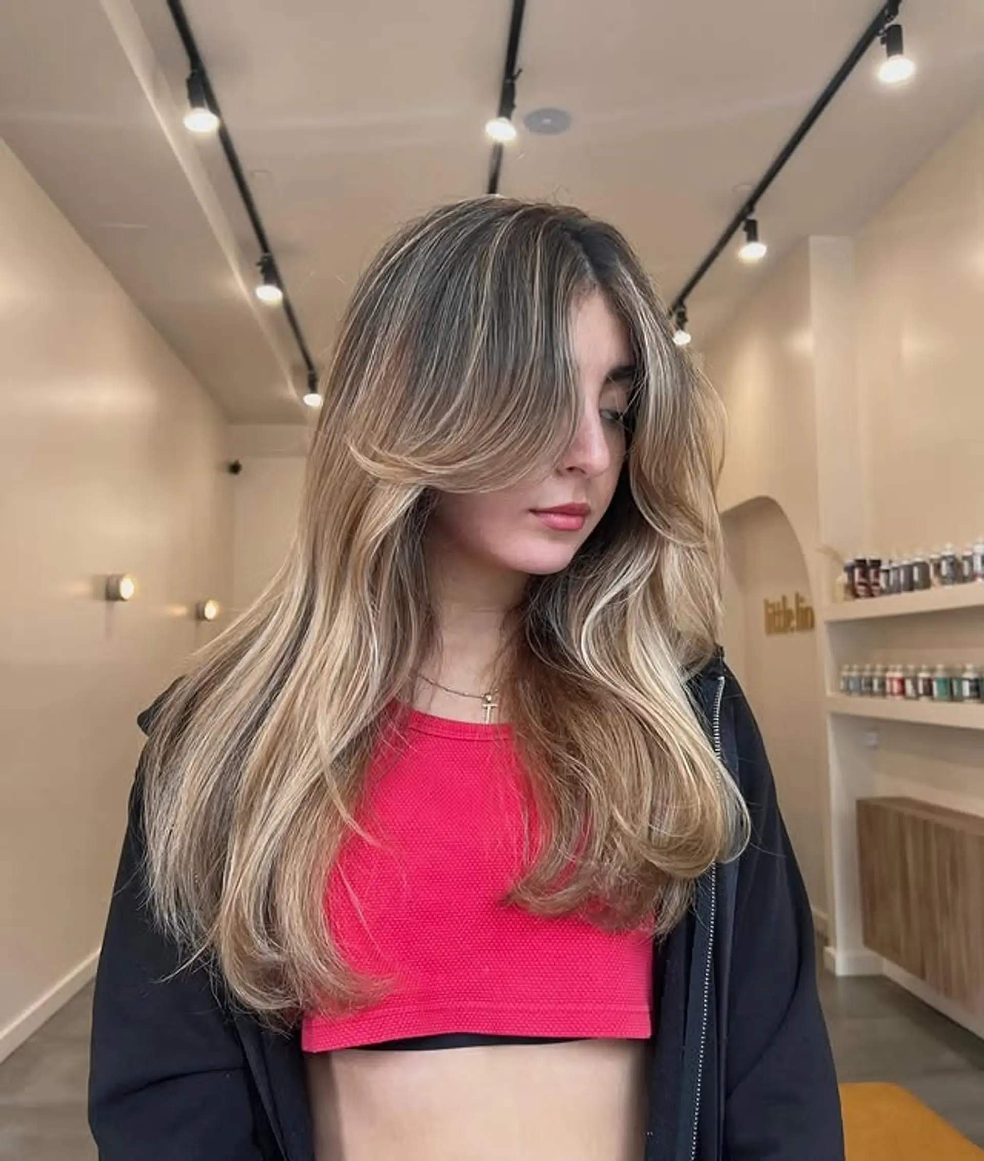 Long layered hairstyle with face-framing layers and curtain bangs. 1