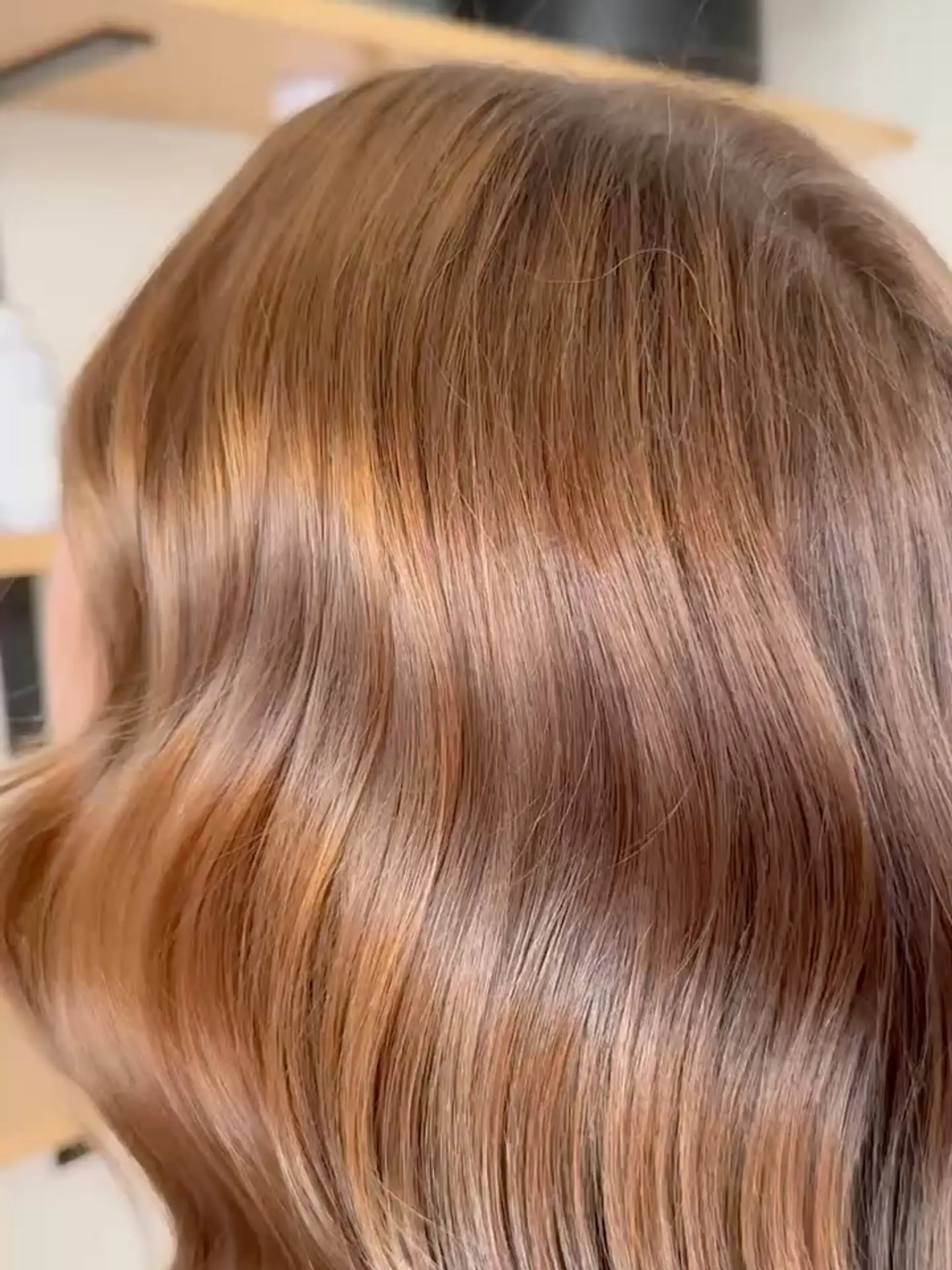 Shiny warm caramel brown hair styled into smooth, seamless waves. 1