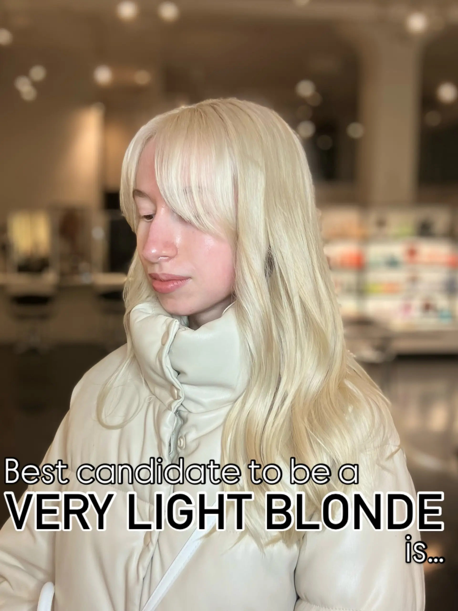 Pale platinum blonde hair styled in soft waves with textured, face-framing bangs. 1