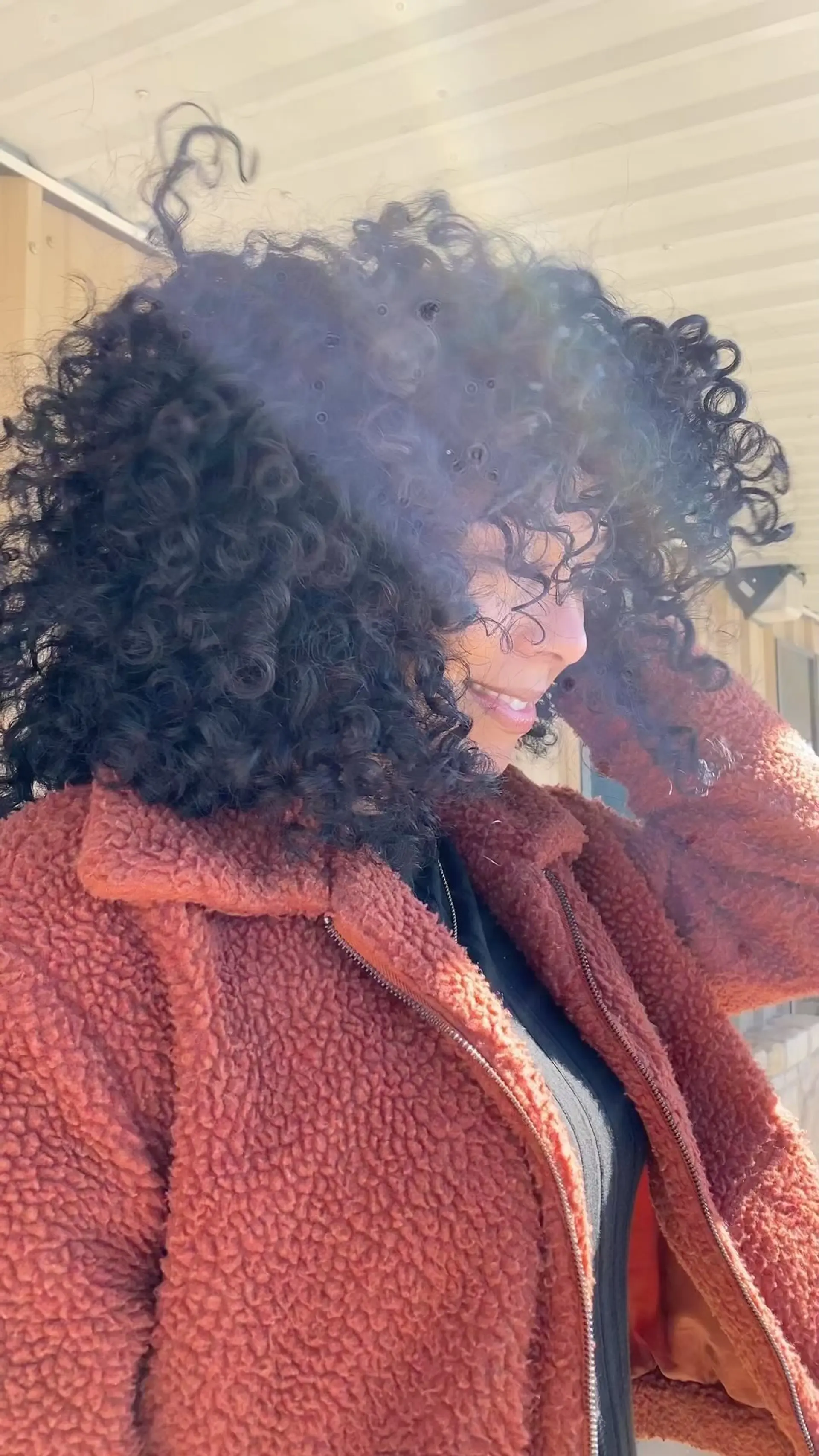 Voluminous curly cut featuring rounded layers and curly bangs. 1