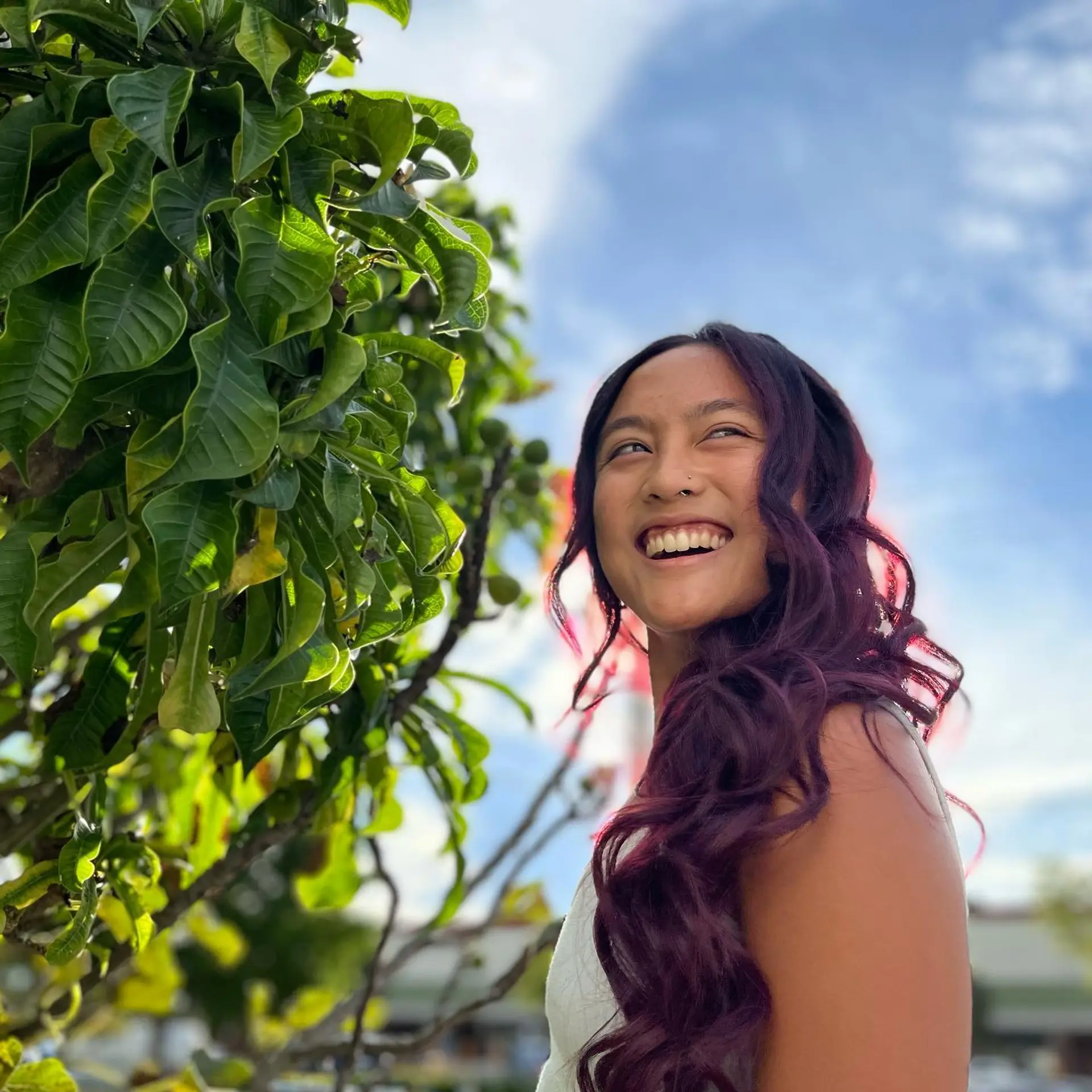 Long, wavy hair with a trendy burgundy color and dark roots. 3