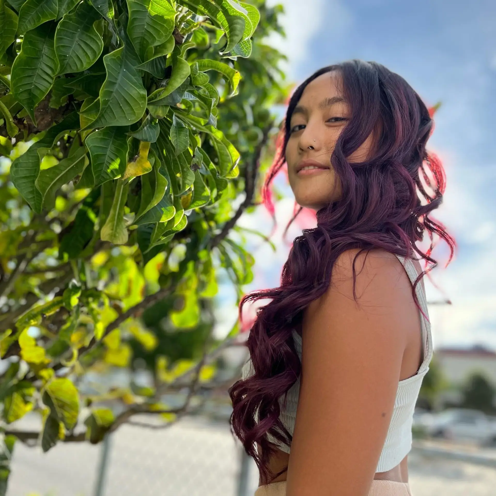 Long, wavy hair with a trendy burgundy color and dark roots. 4