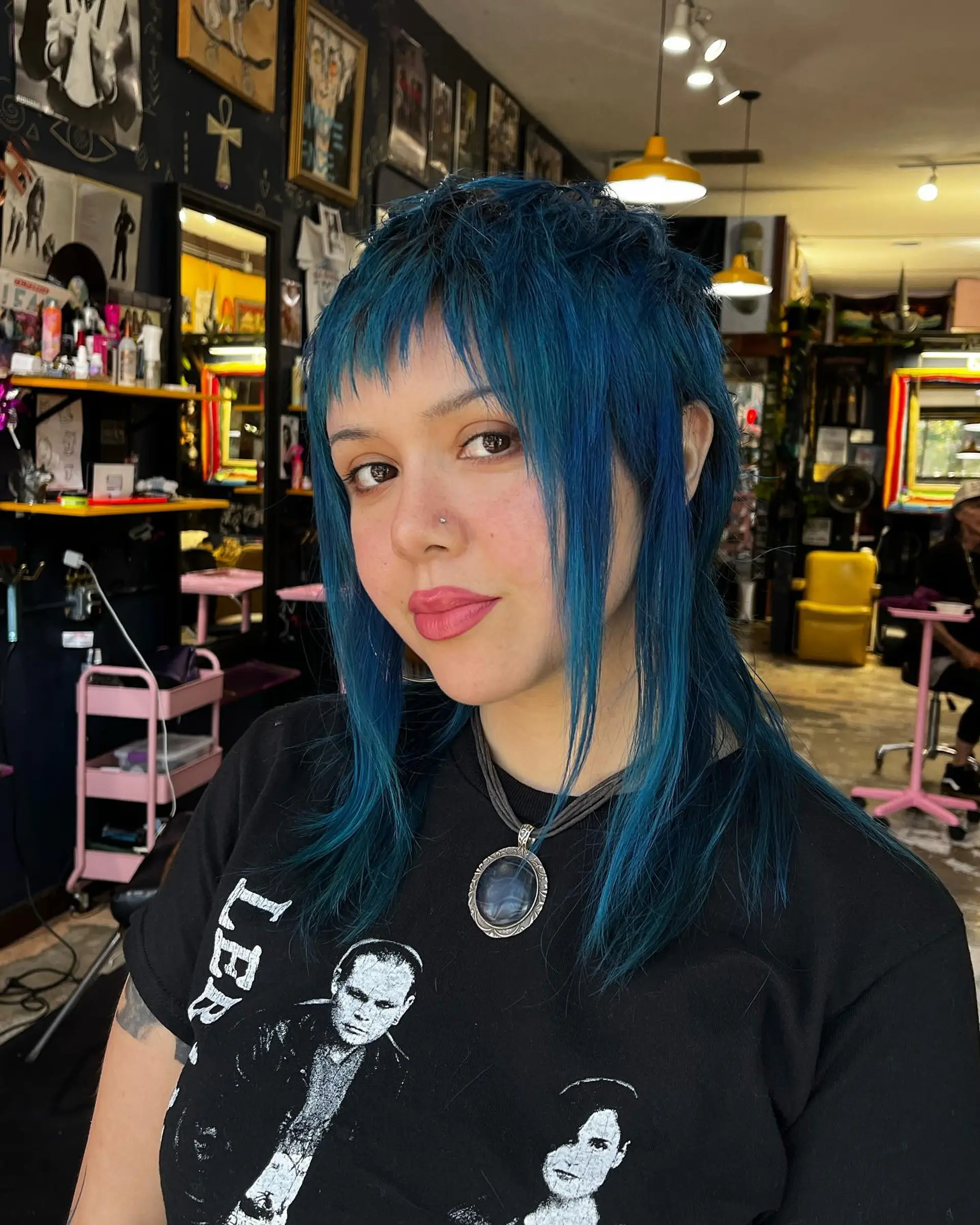 A textured vivid blue shaggy mullet featuring choppy micro bangs and long face-framing pieces. 1