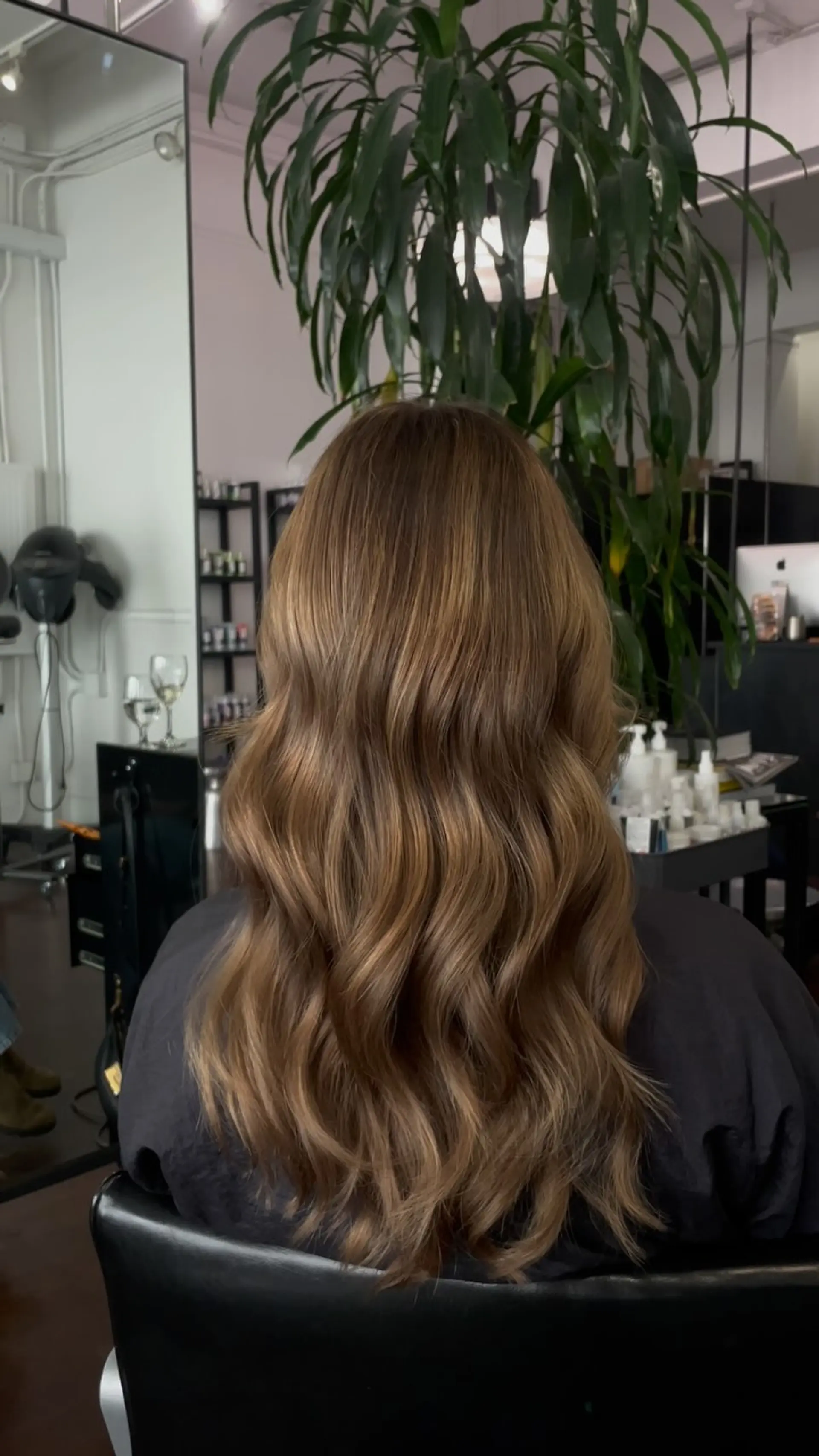 Long mocha brown hair styled with soft, cascading waves and subtle dimensional highlights. 1