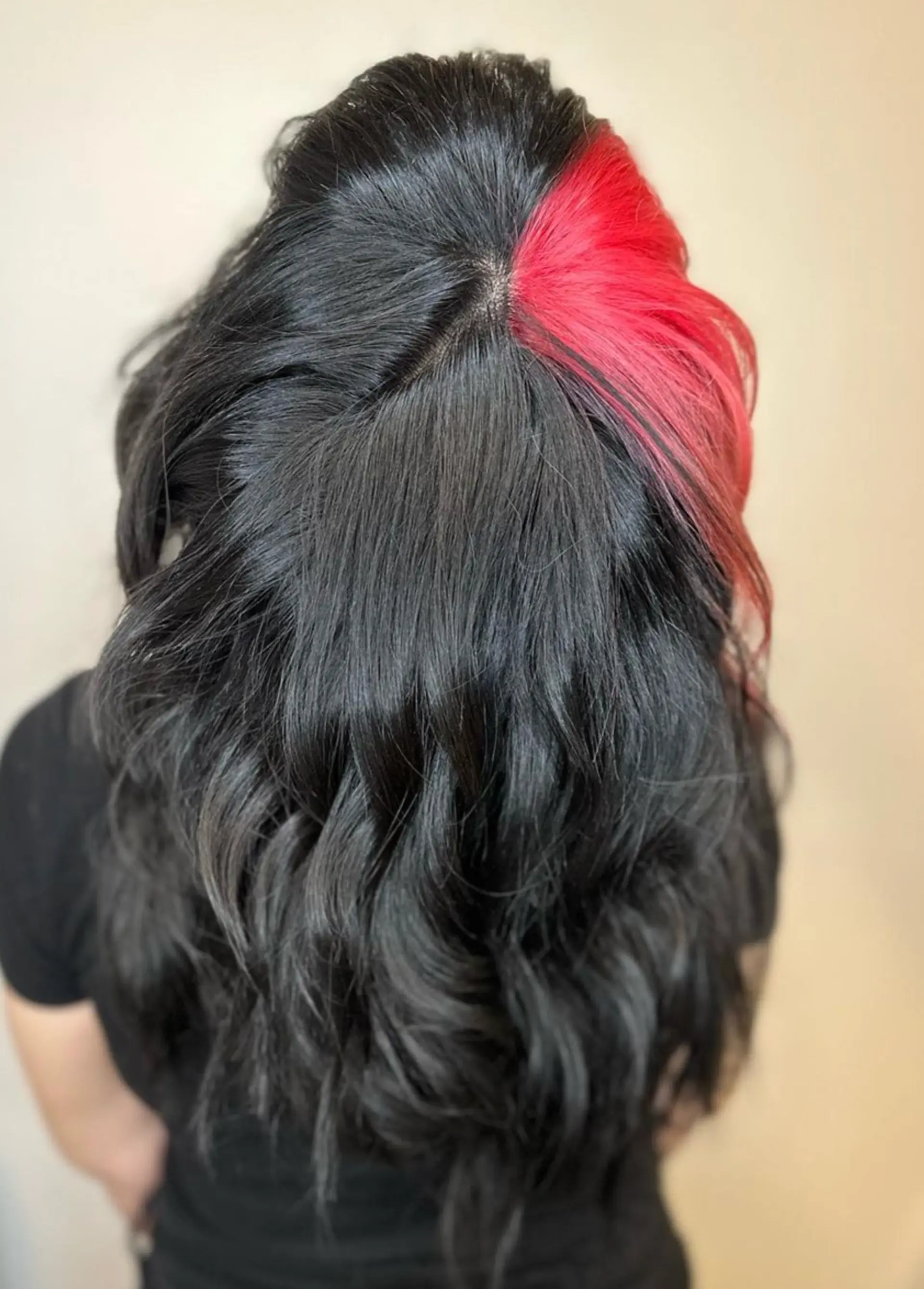 Medium length wavy hair with a two-tone color scheme of black and red, featuring choppy bangs above the eyebrows for an edgy look.

Color by @simabeautynyc
 2