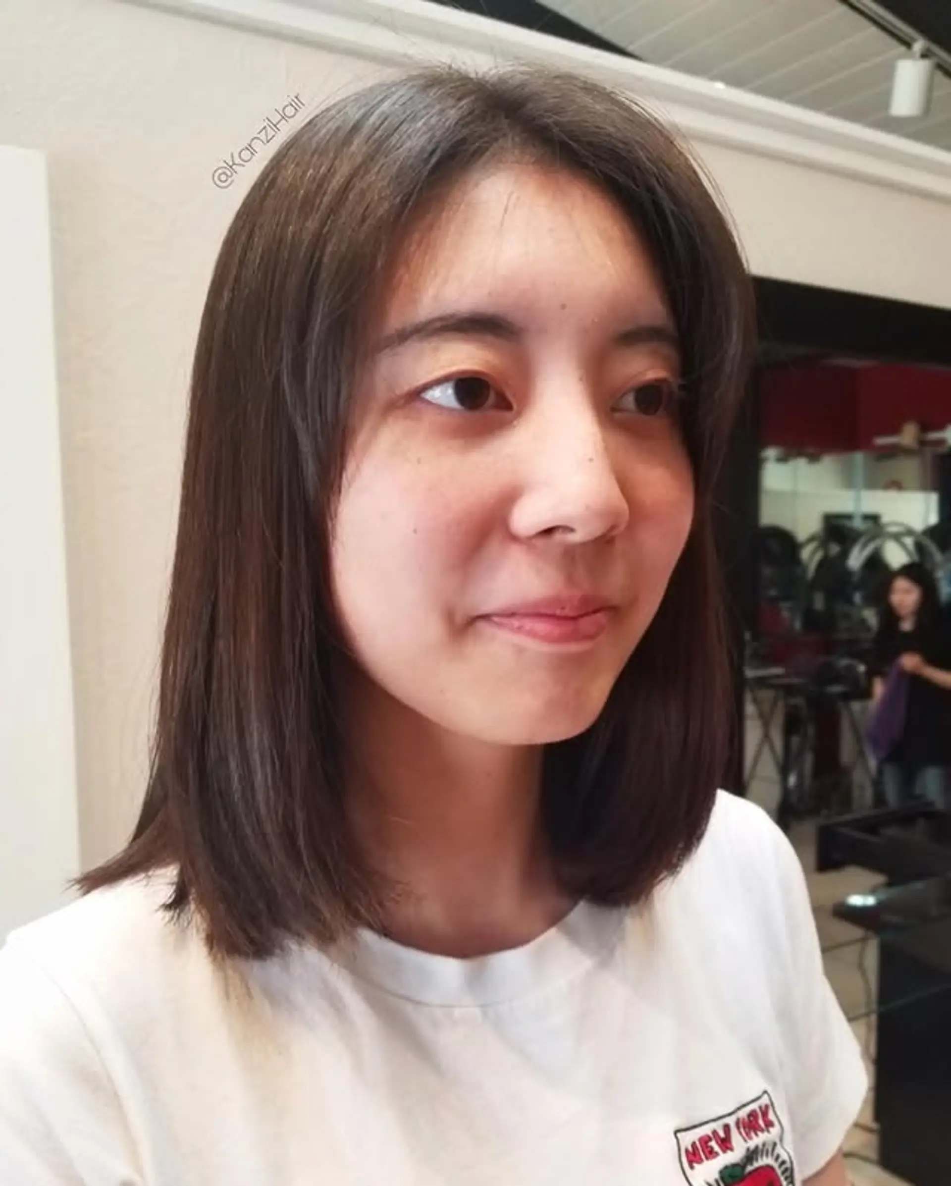 A sleek, medium-length lob featuring soft, subtle face-framing layers that gently curve inwards, creating a flattering and natural look with movement. 1