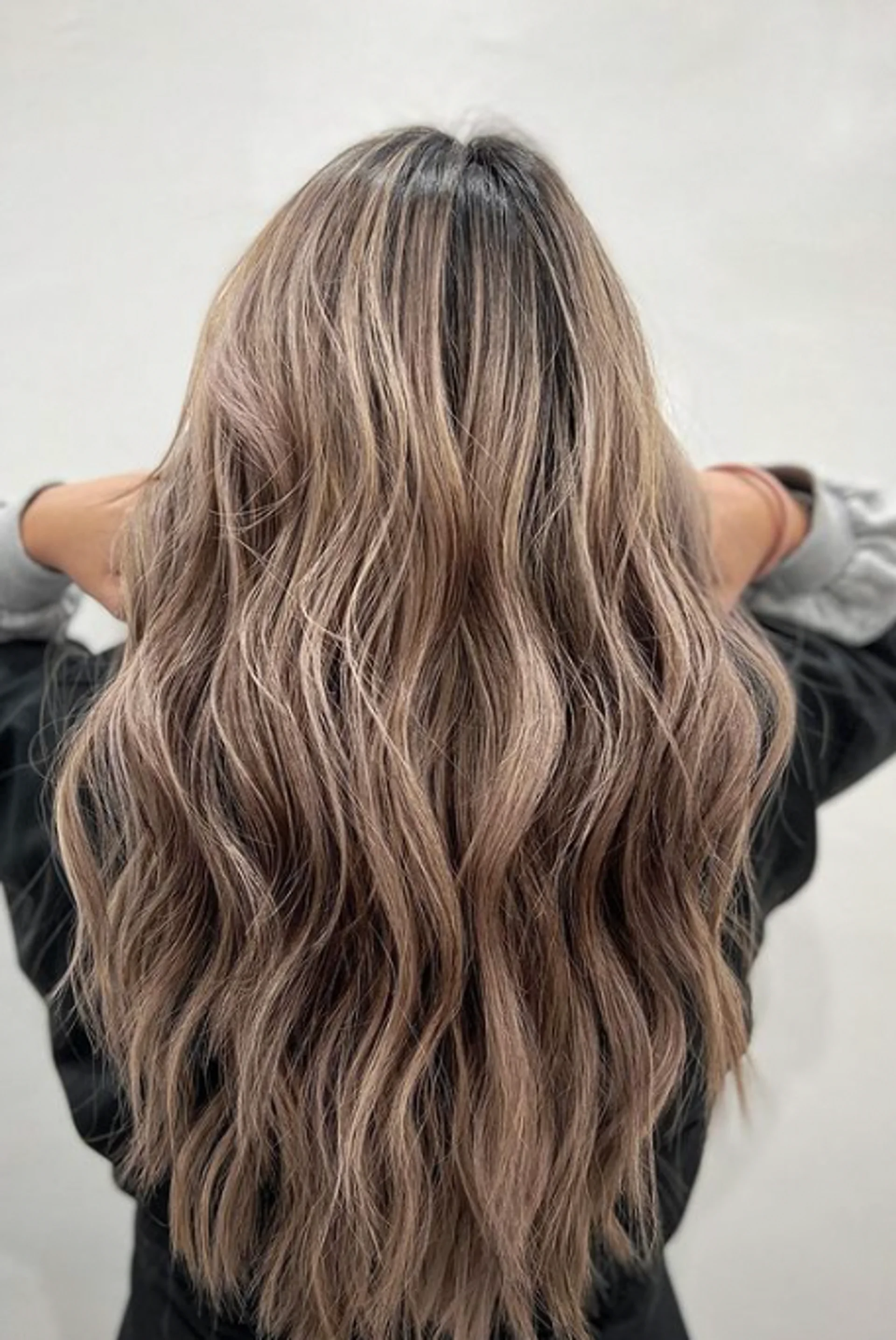 Long wavy bronde balayage hairstyle from a Queens salon. - Preview 3