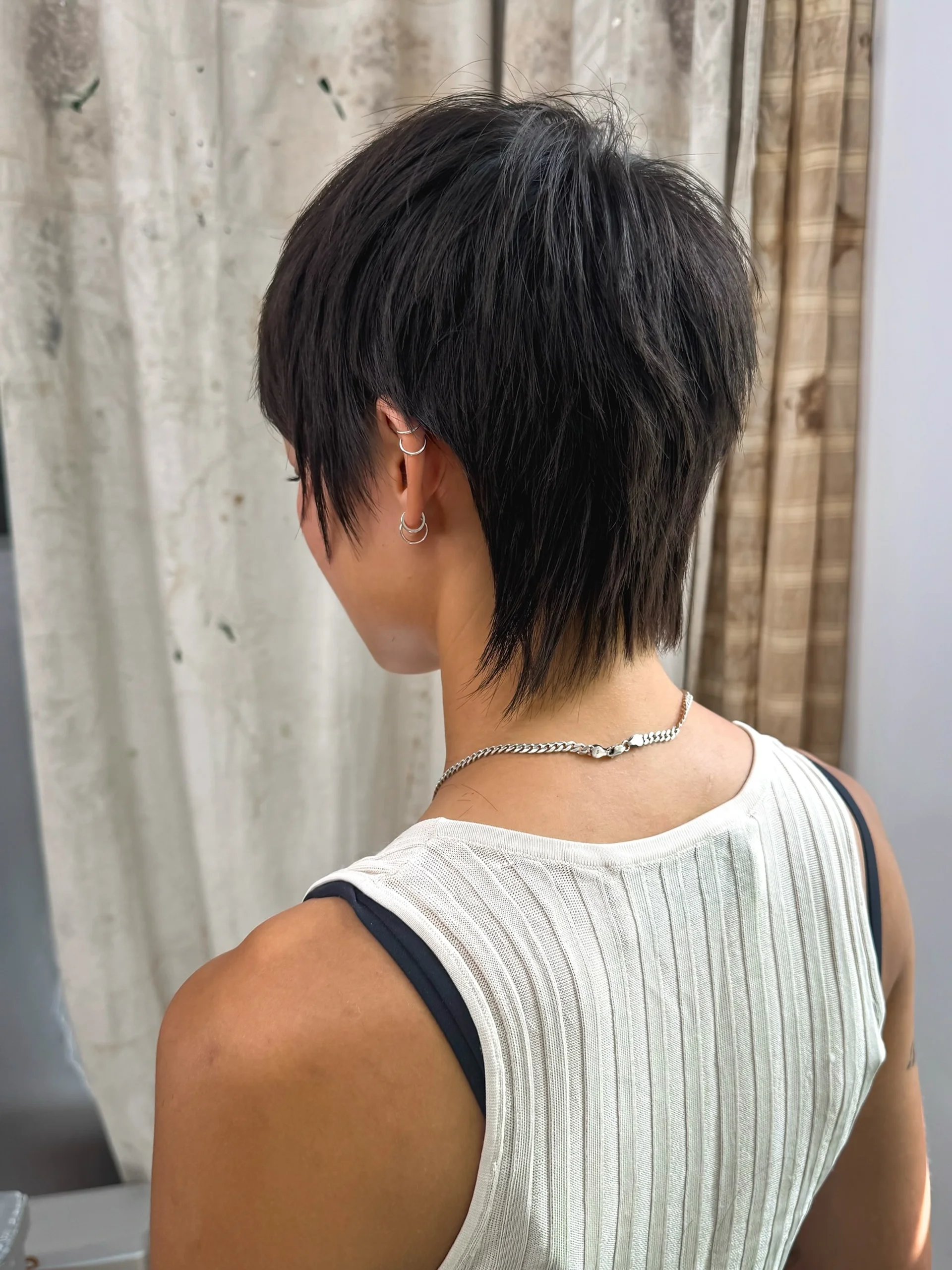 A modern mullet with a sleek, straight finish and choppy layers, representing the edgy East Village aesthetic - Preview 2
