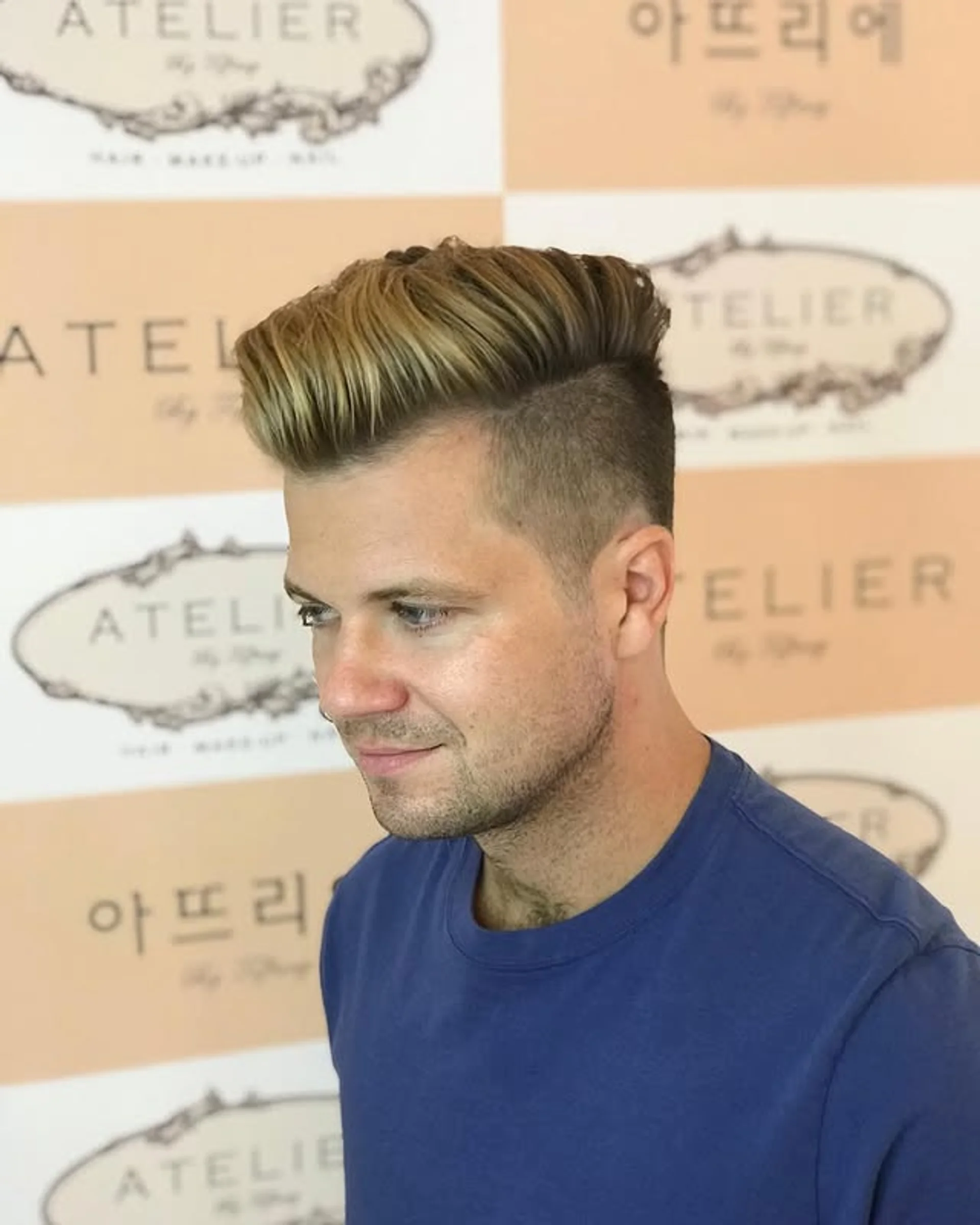 A person with a two-block haircut with very long, straight hair on top and closely cropped sides, viewed from the side. - Preview 2