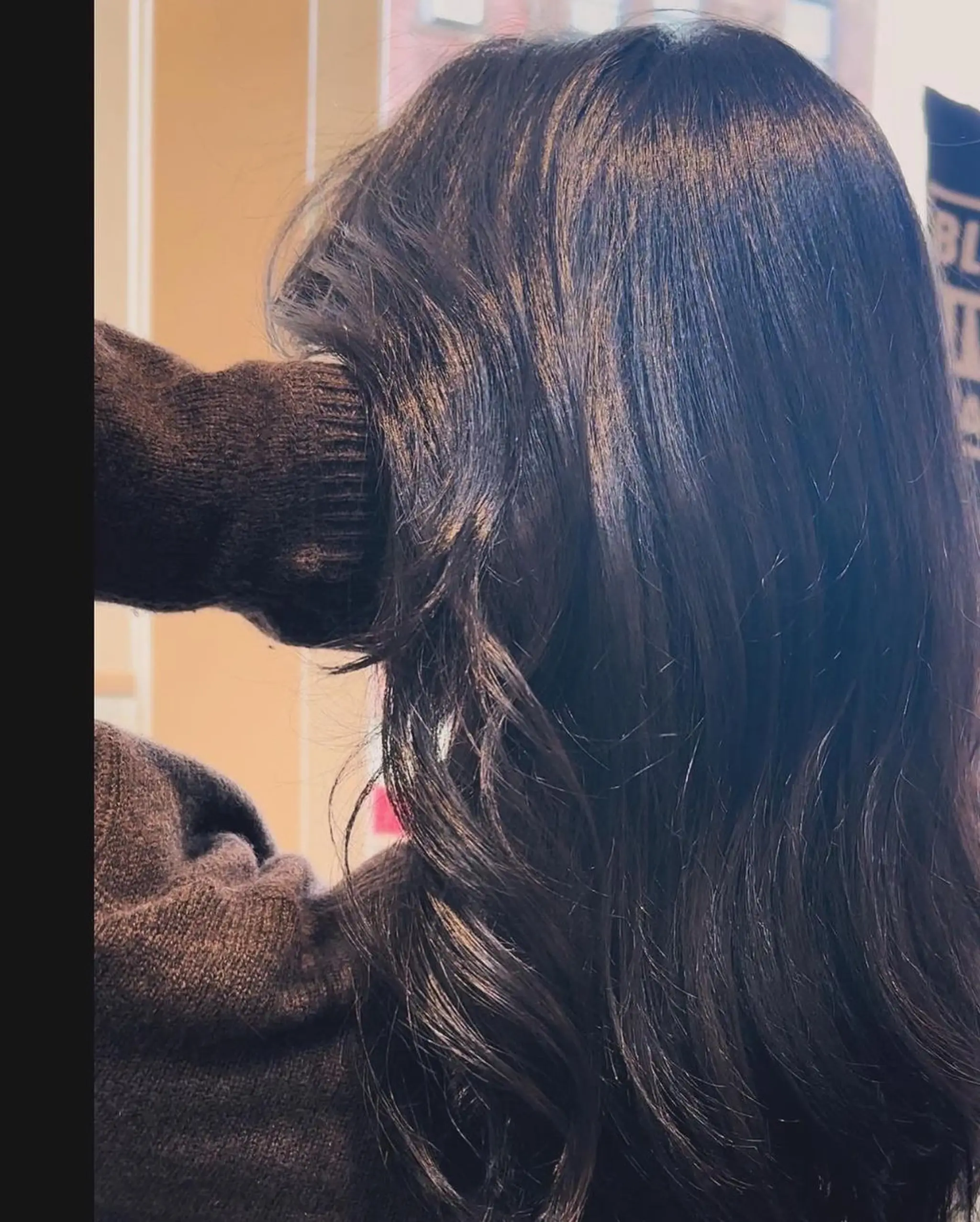 Long, wavy, black hair with a glossy finish and a side part, styled in soft waves. 2