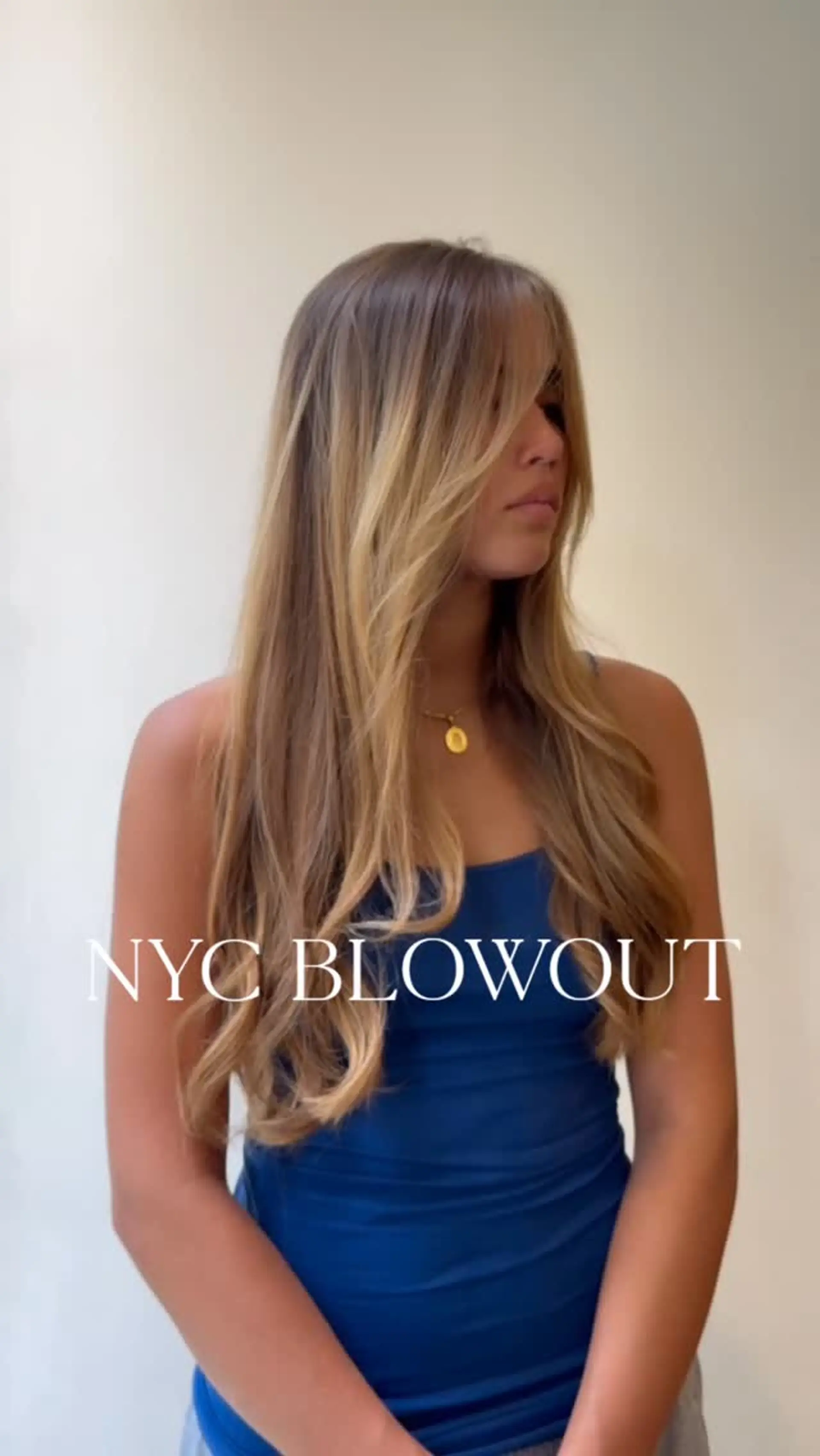 Long layered honey-blonde hair styled in a sleek, bouncy blowout with soft face-framing curtain bangs. 1