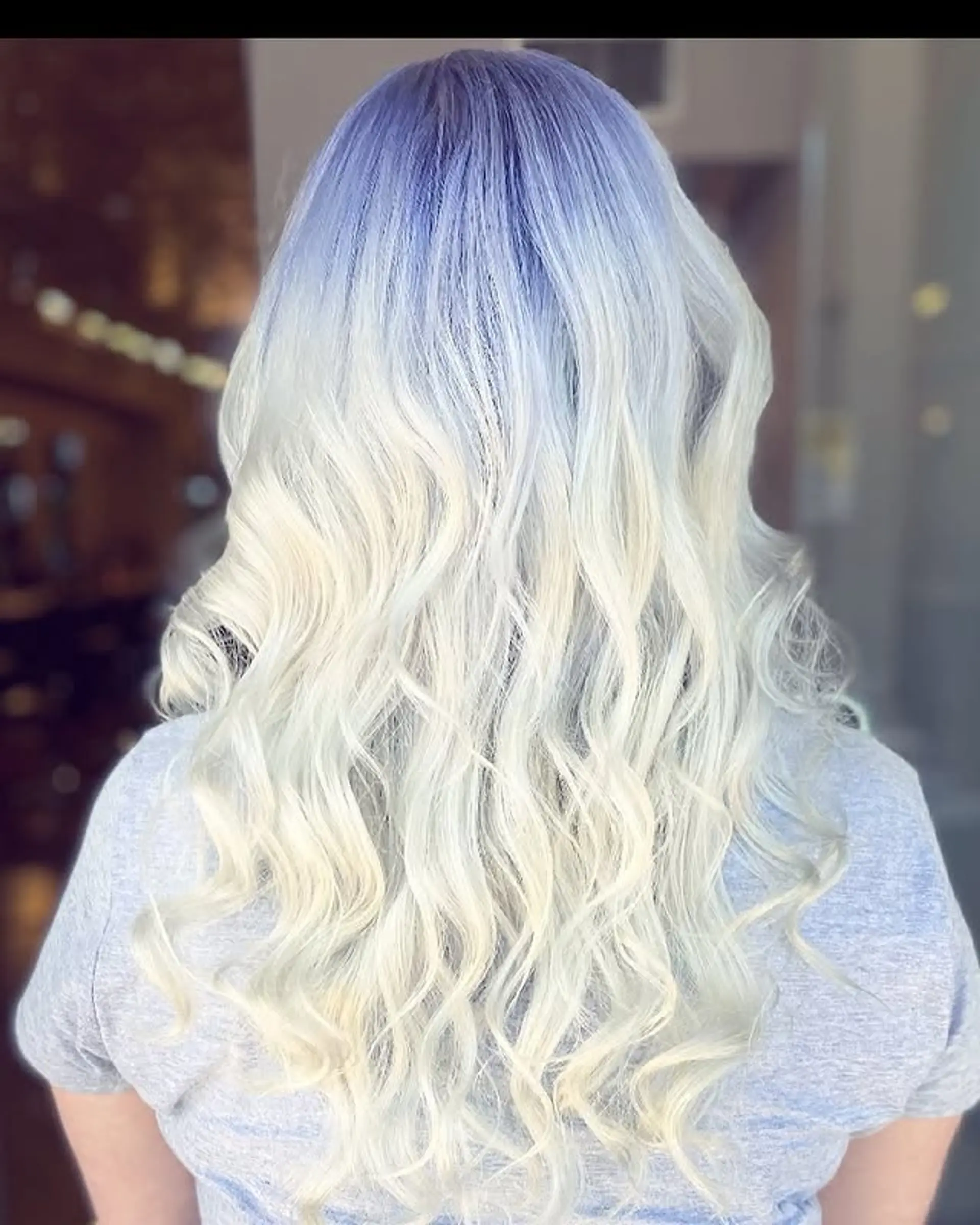 Long, wavy hair with a lavender to platinum blonde ombre effect. 1