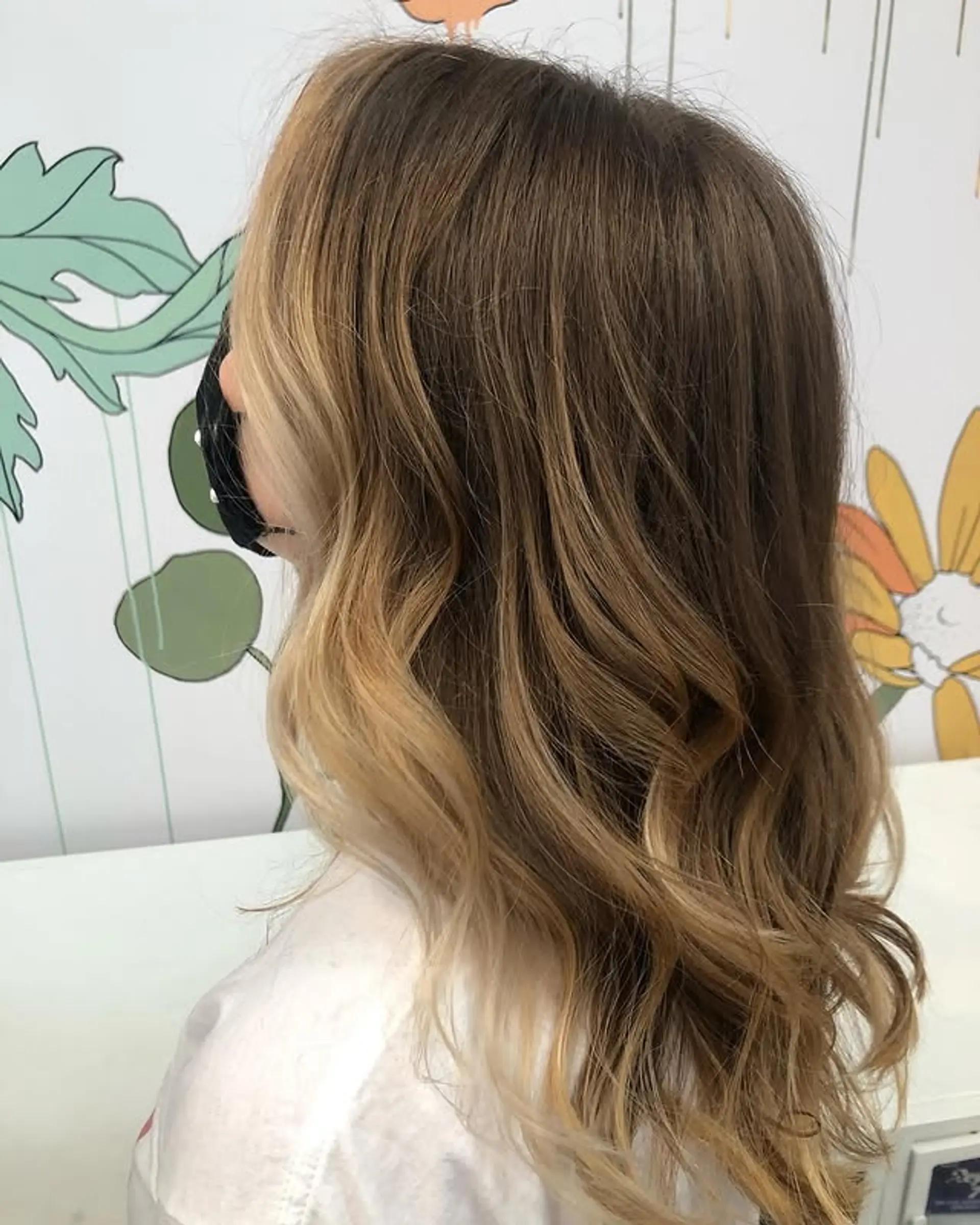 Long wavy hair with face-framing blonde highlights, transitioning from brown at the roots. 1