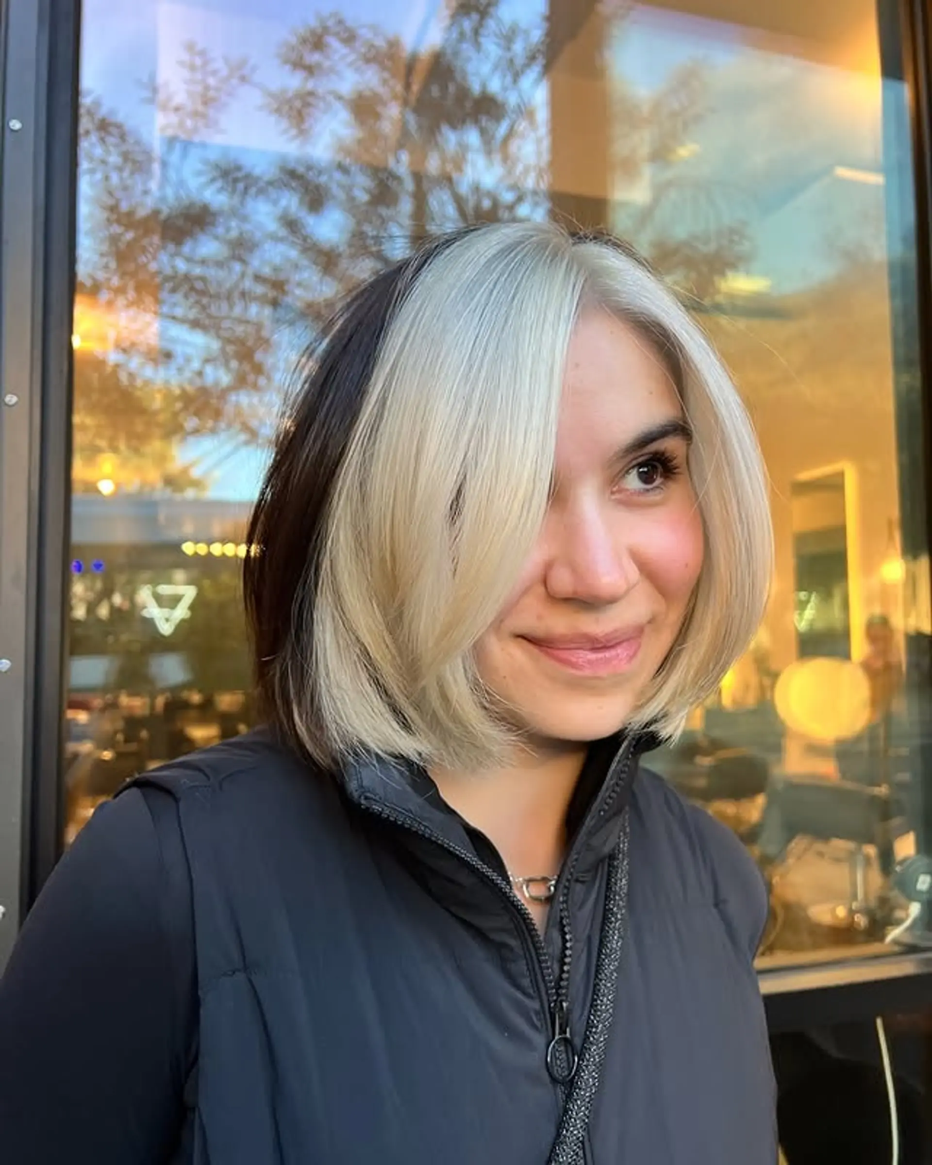 A stylish, face-framing bob with a striking money piece. 1