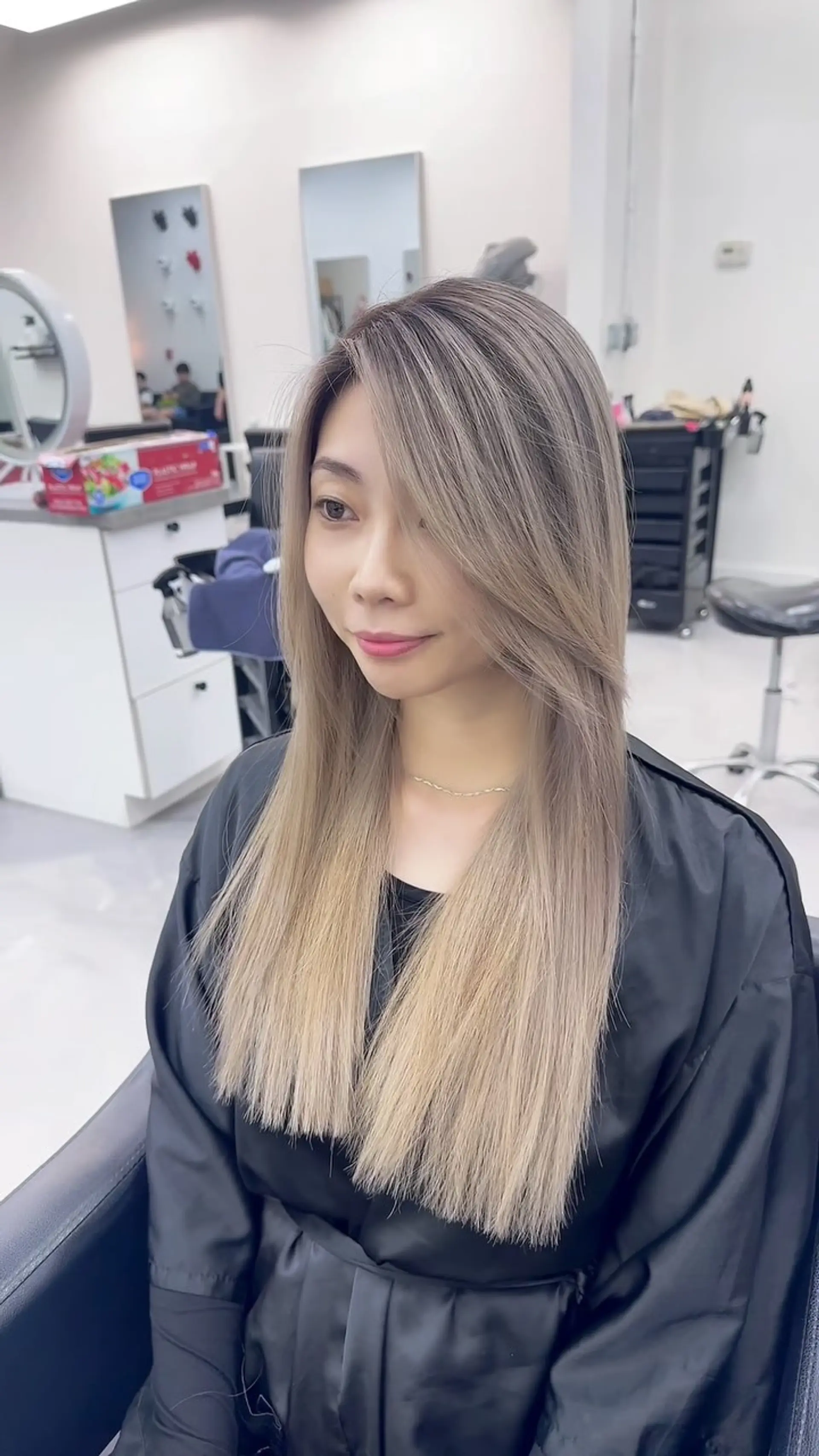 Sleek straight long hair in a cool-toned light ash blonde shade with soft face-framing layers and side-swept bangs. 1