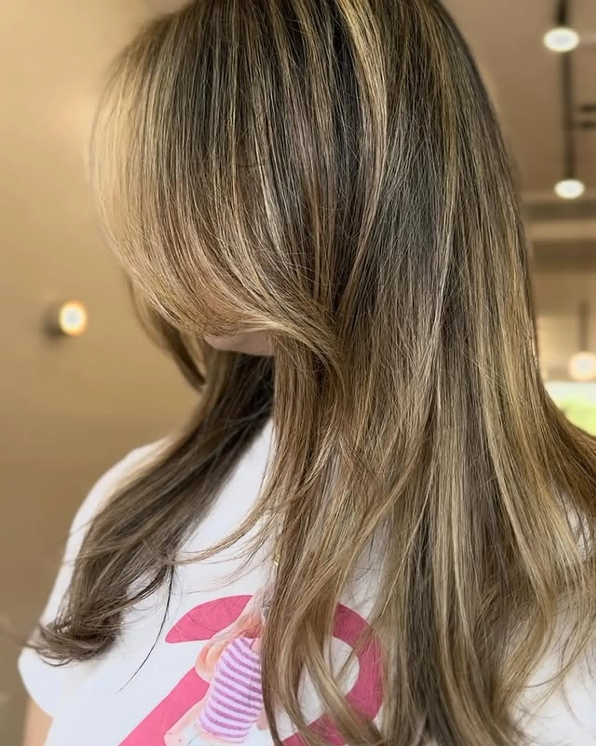 Long, layered haircut with bronde balayage. 1