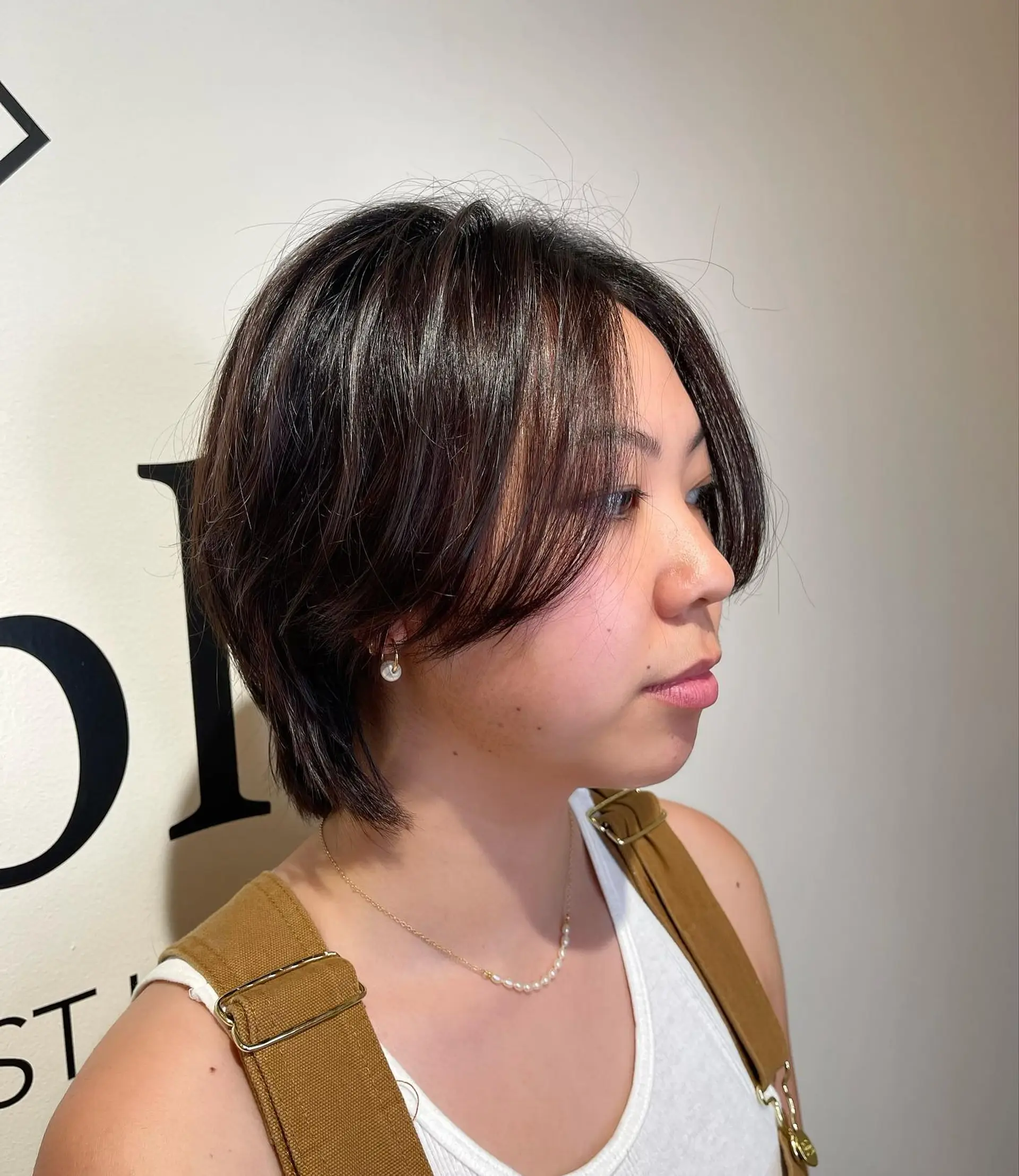 A textured short layered bixie cut with soft, face-framing curtain bangs and gentle piecey layers. 1