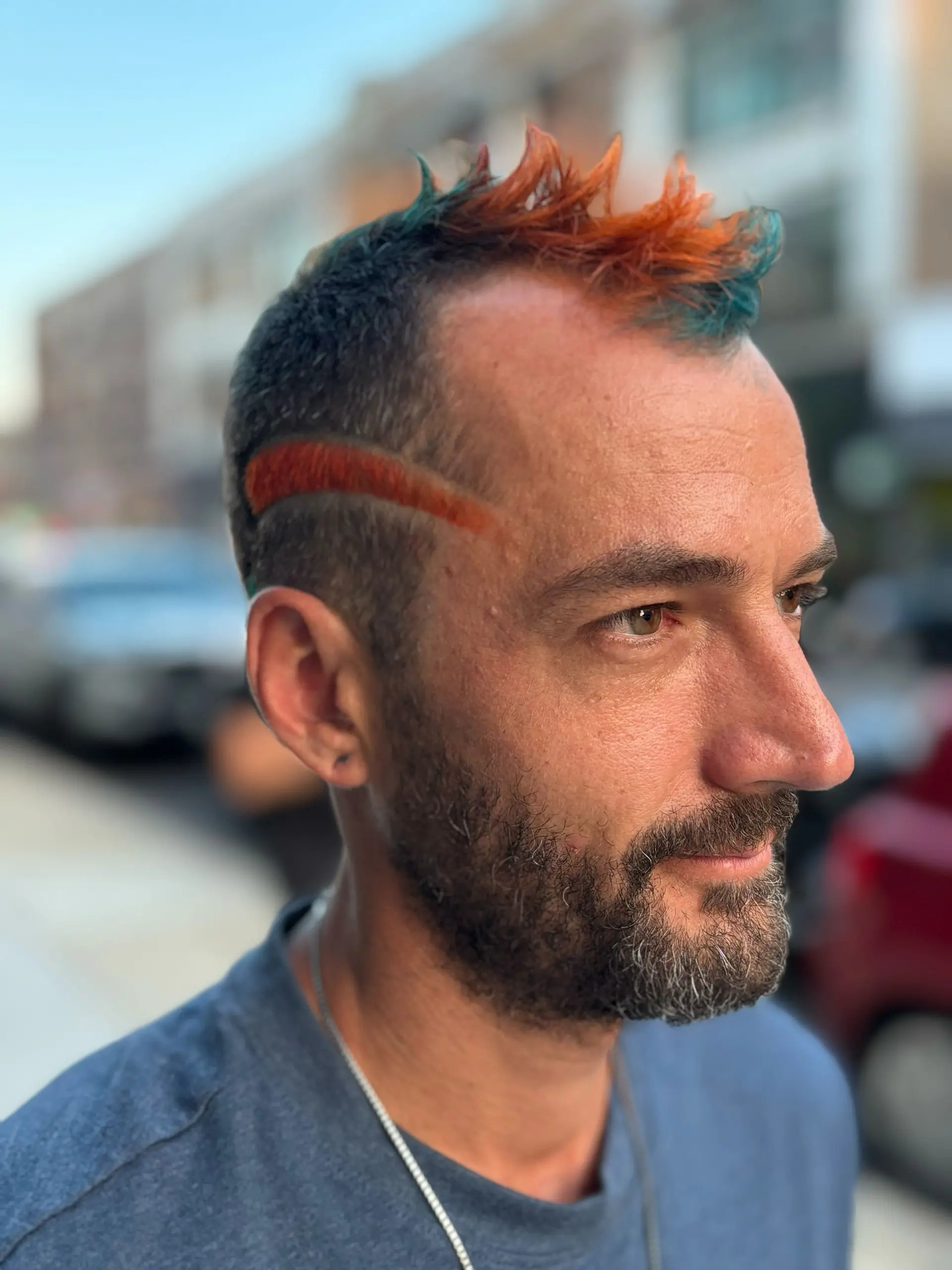 A modern take on a mullet and mohawk, combining the edgy silhouette with colorful spikes. 2