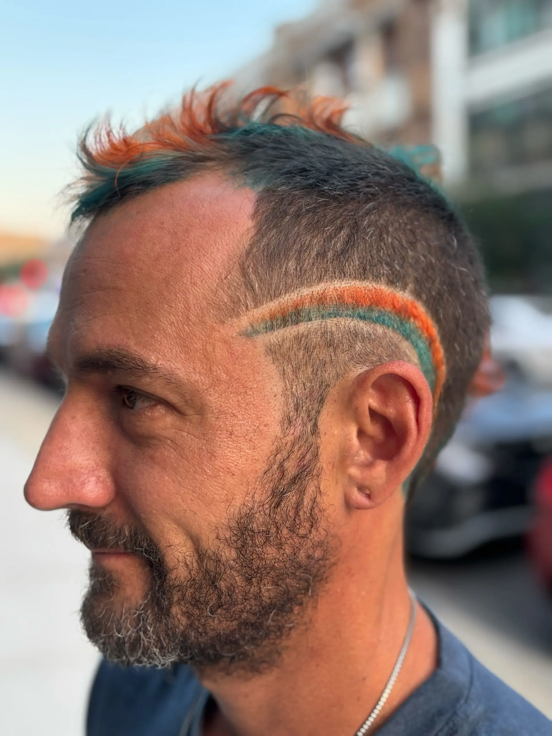 A modern take on a mullet and mohawk, combining the edgy silhouette with colorful spikes. 3