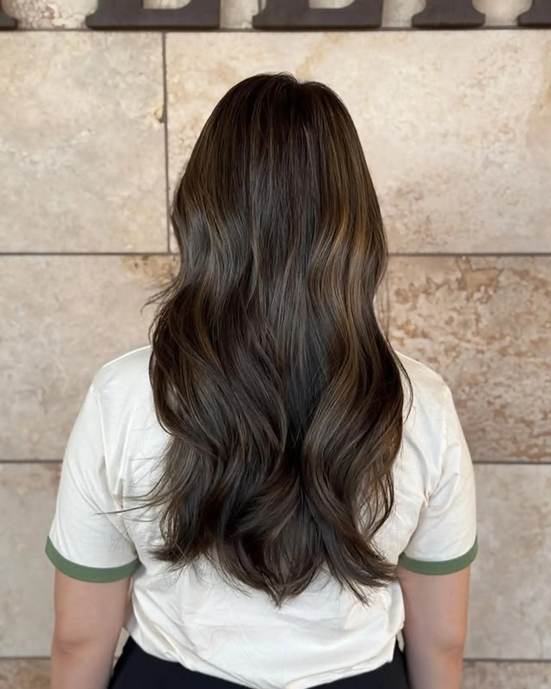Long layered hair with subtle waves and balayage highlights. 1