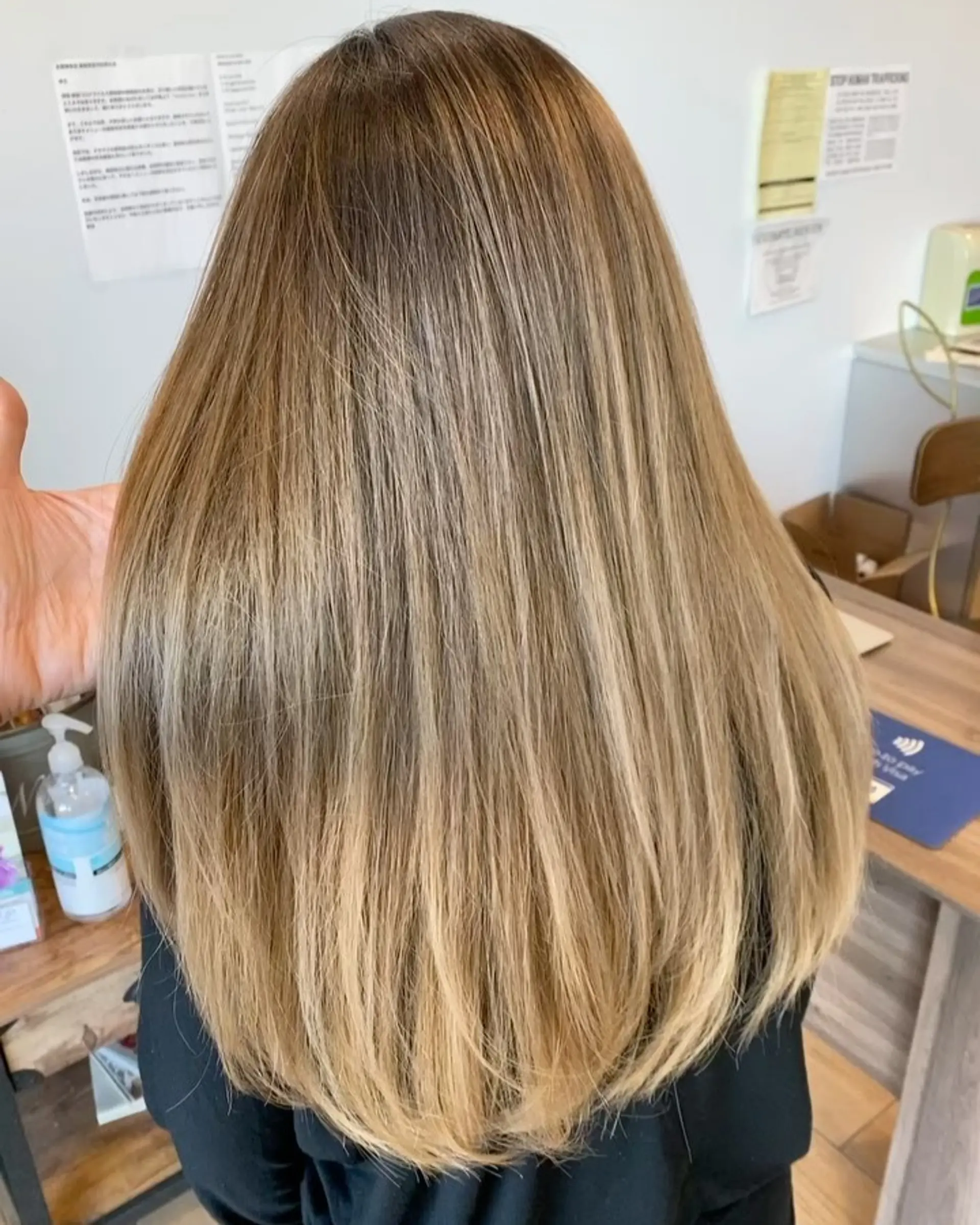 Long straight hair showcasing a seamless balayage gradient from natural roots to bright beige-blonde ends. 1