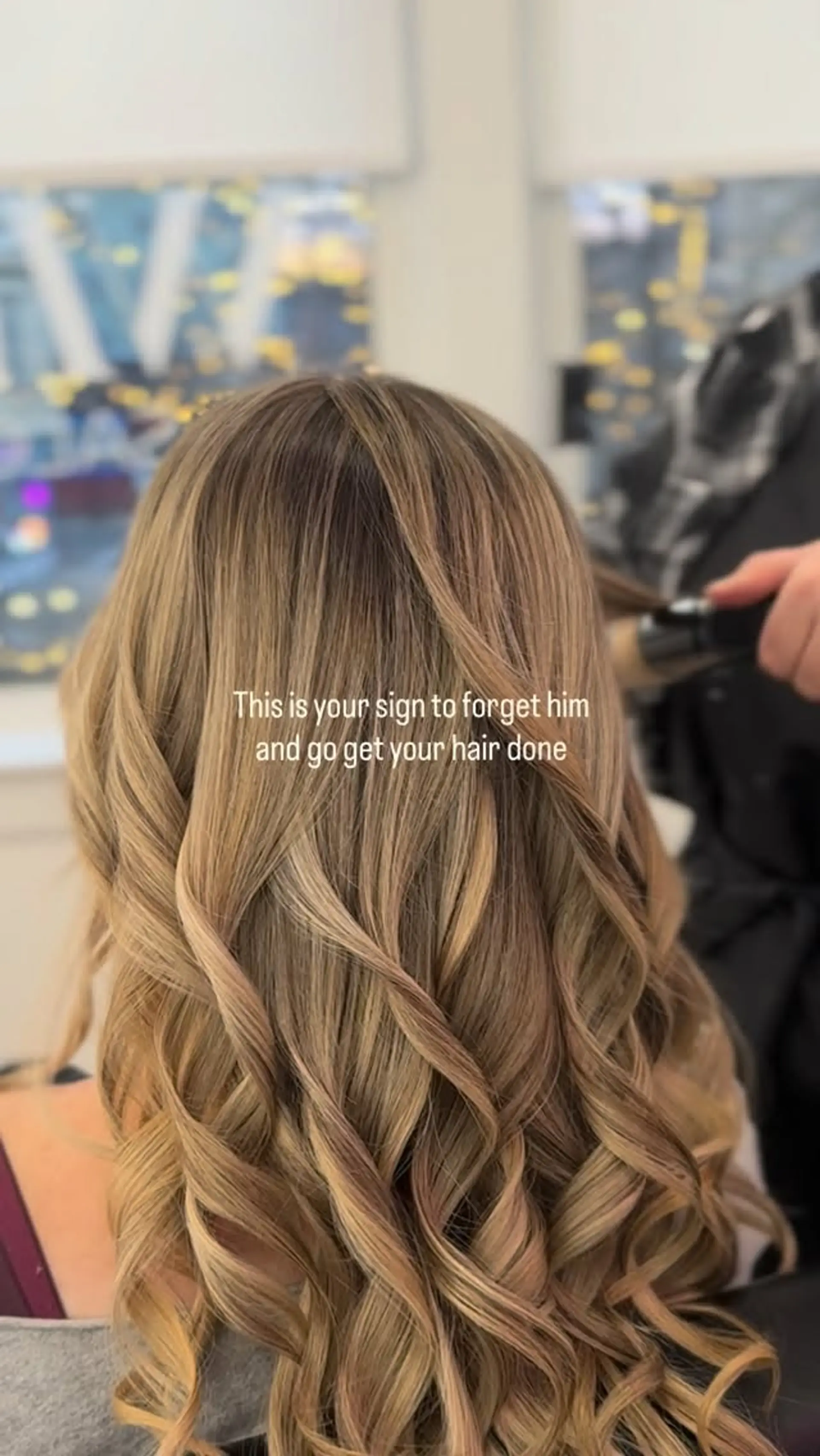 Long dimensional blonde hair styled into smooth, defined curling iron waves. 1
