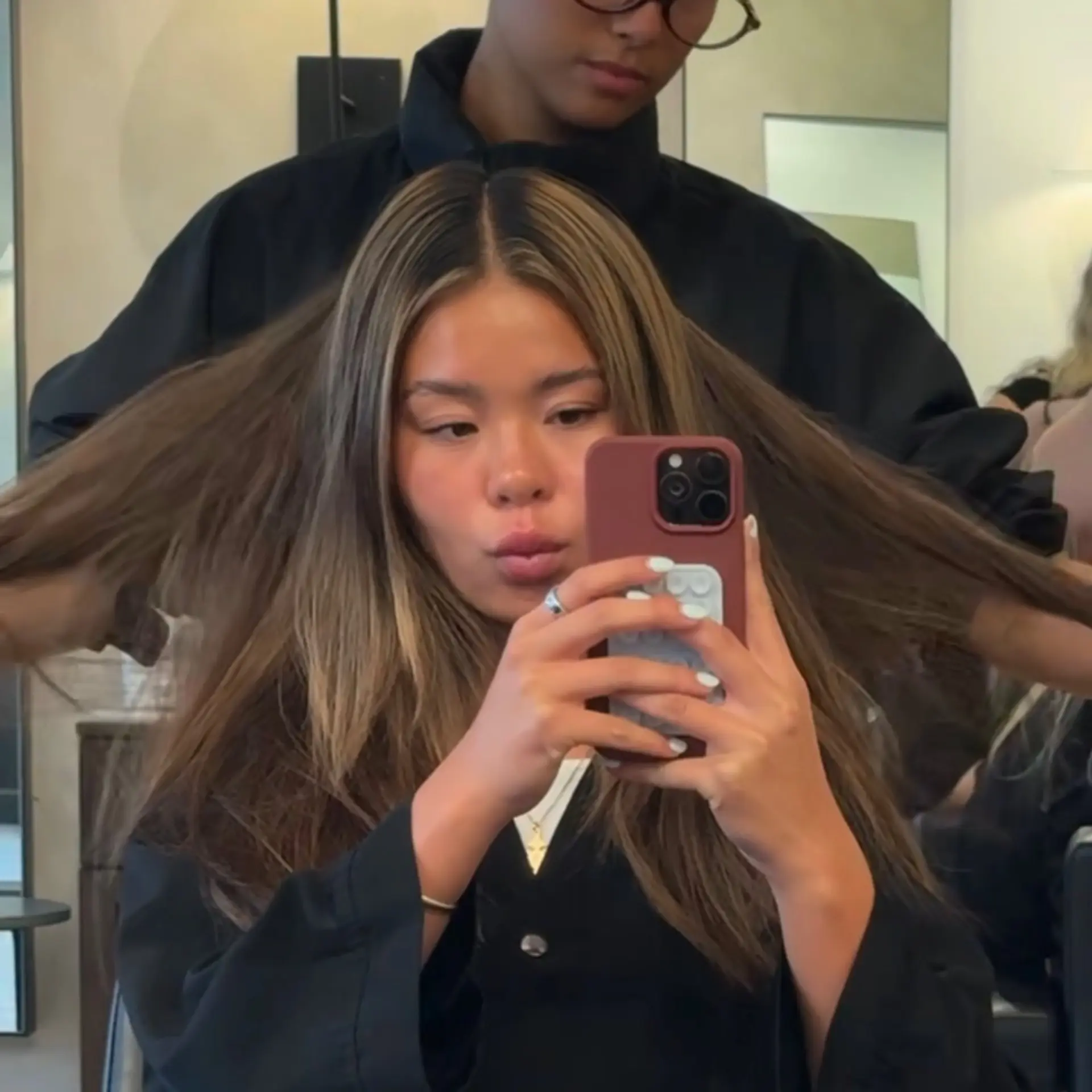Long layered dimensional bronde hair styled with a smooth, airy blowout. 1