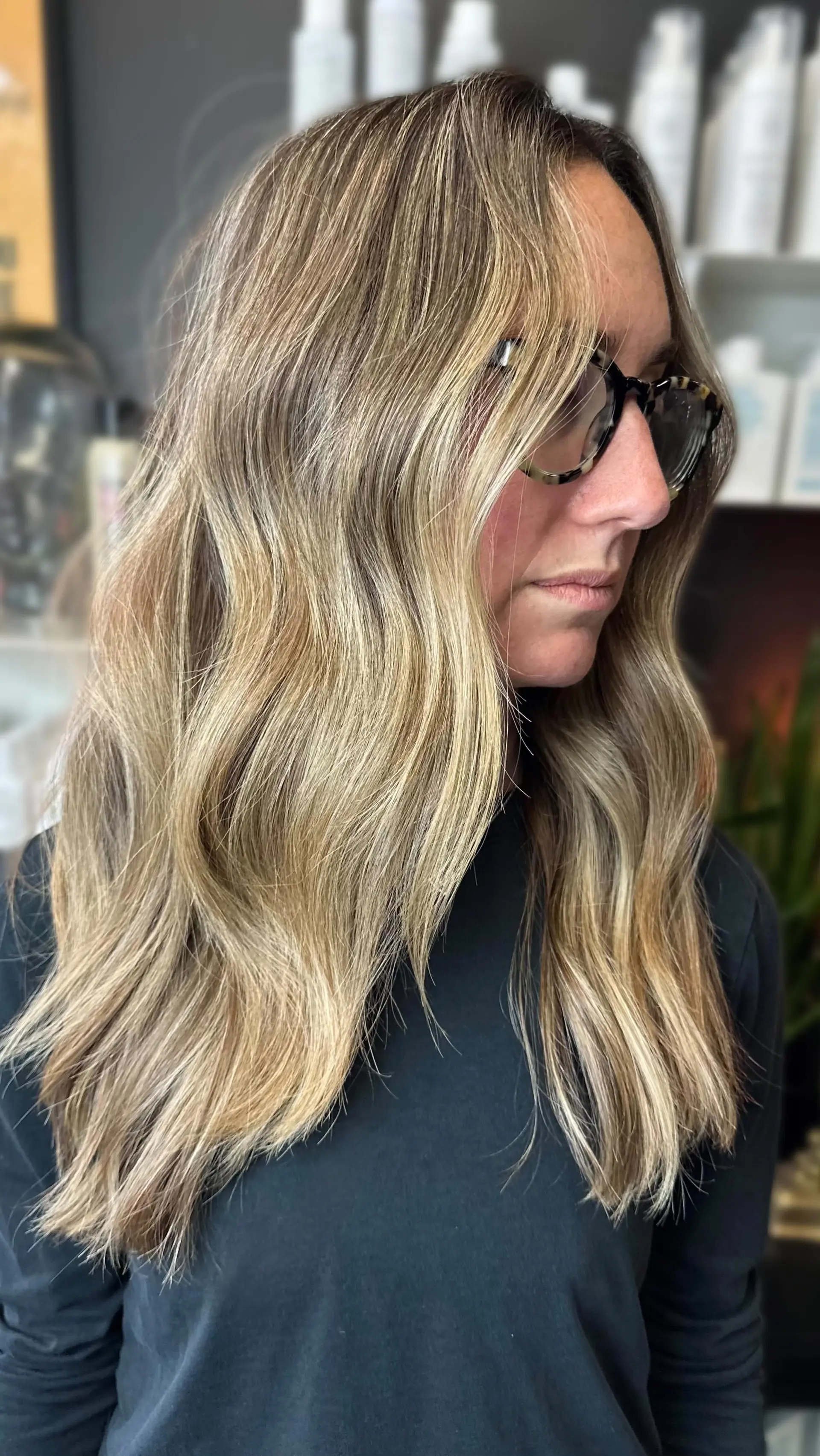 Long dimensional blonde hair cut with light layering and styled into soft, effortless waves. 1