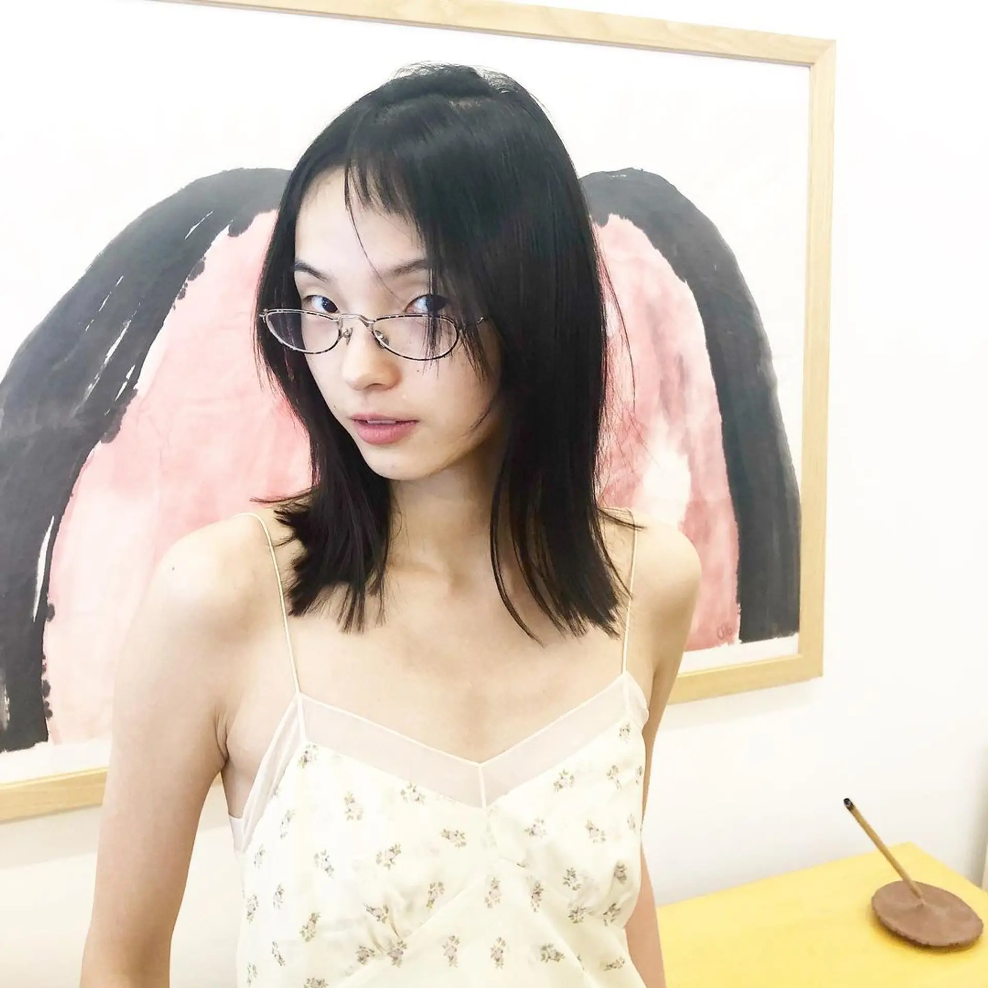 This hairstyle features medium-length straight black hair with choppy ends, layered sections, and curtain bangs framing the face by Takeo. 1