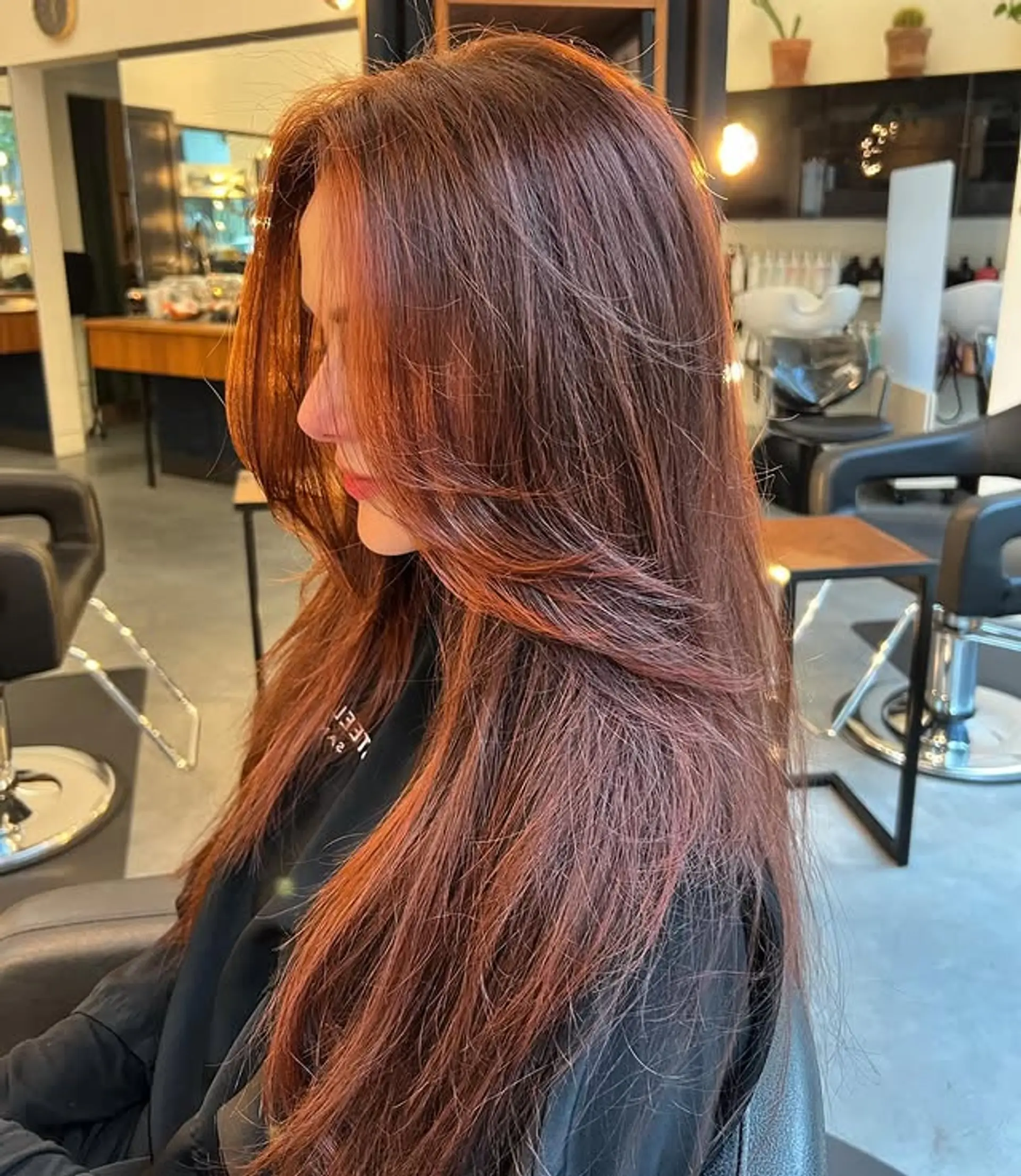 Long layered haircut with face-framing layers. 1