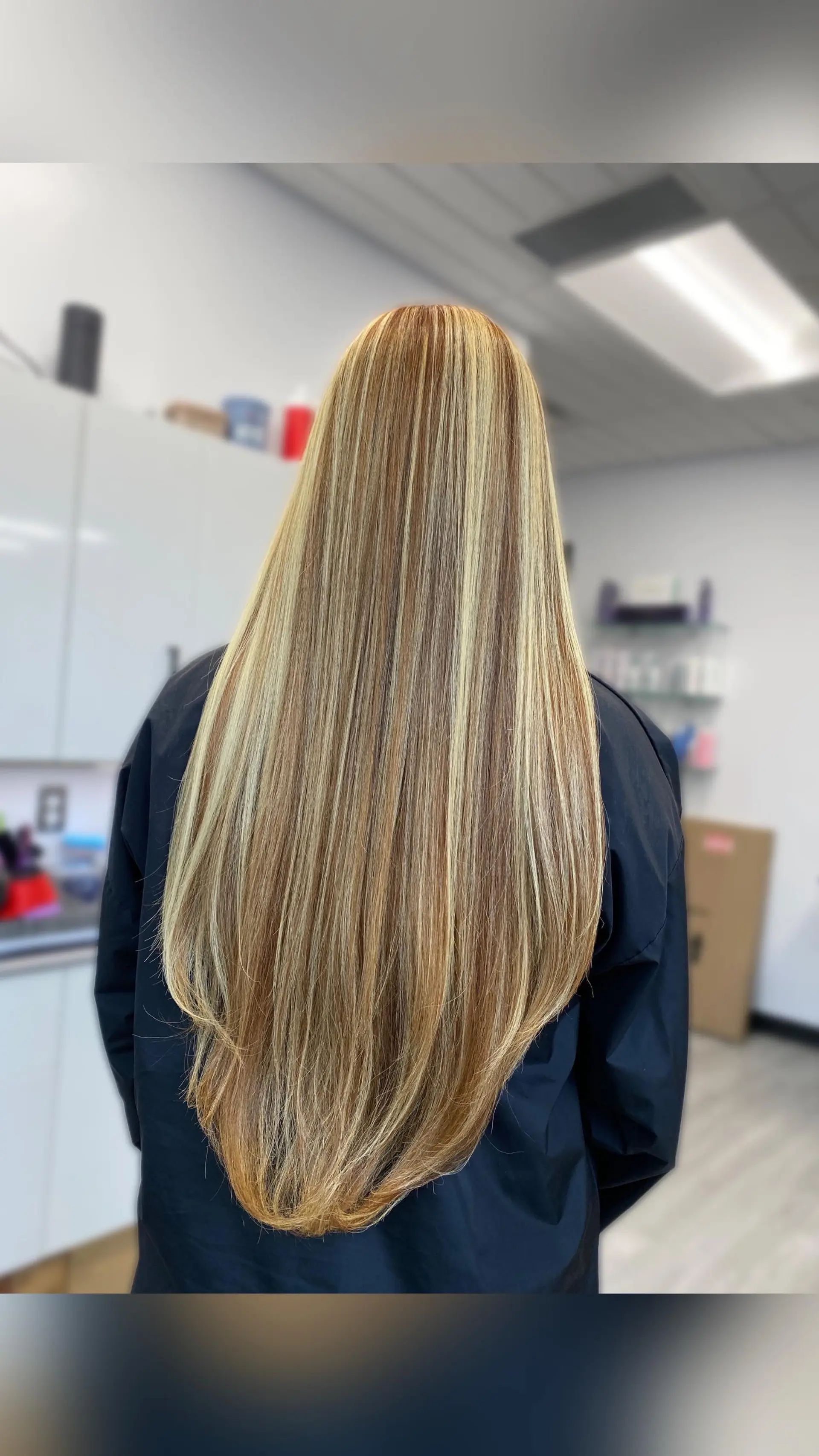 Extra-long straight hair styled sleek with dimensional warm honey and caramel foil highlights over a light brown base. 1