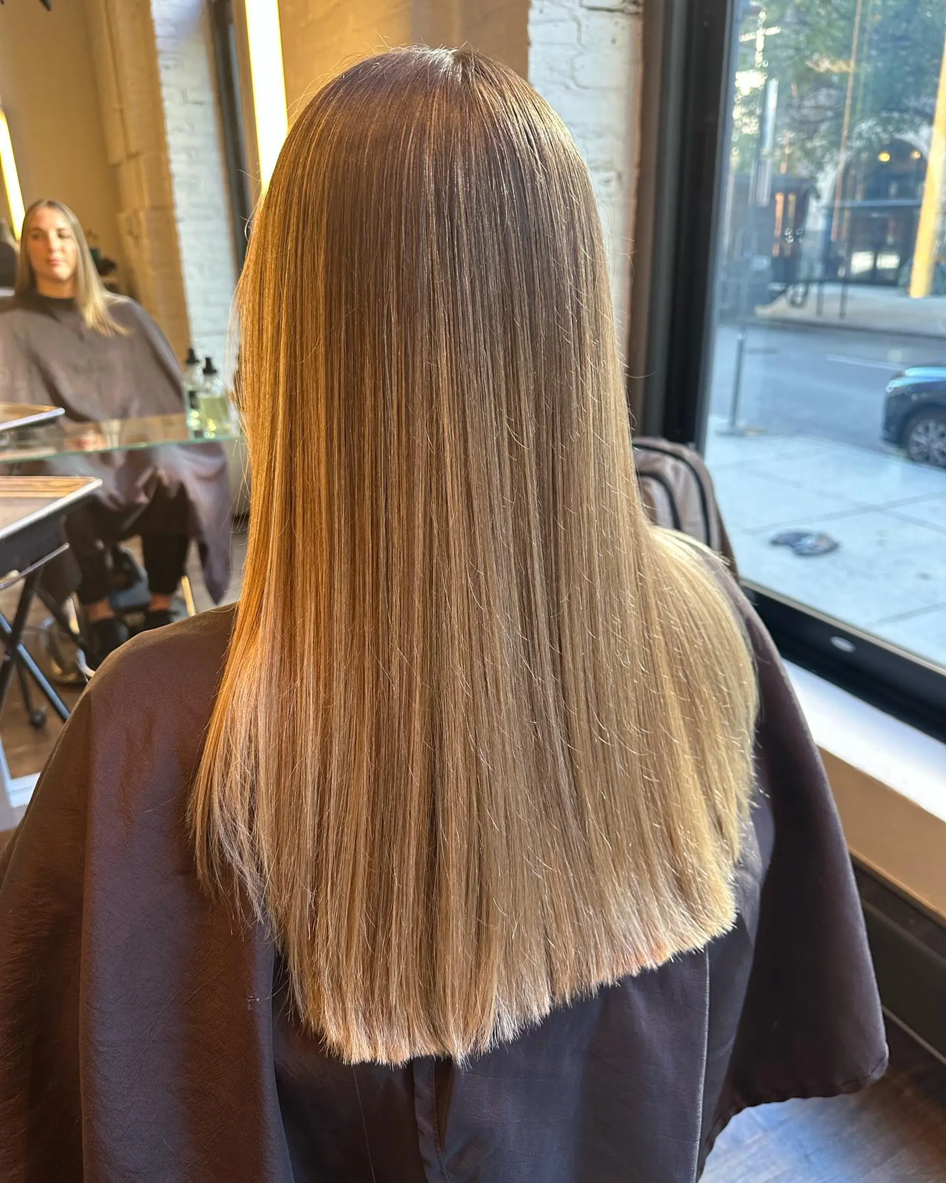 Long, straight hair with subtle face-framing layers and a warm honey blonde color. 1