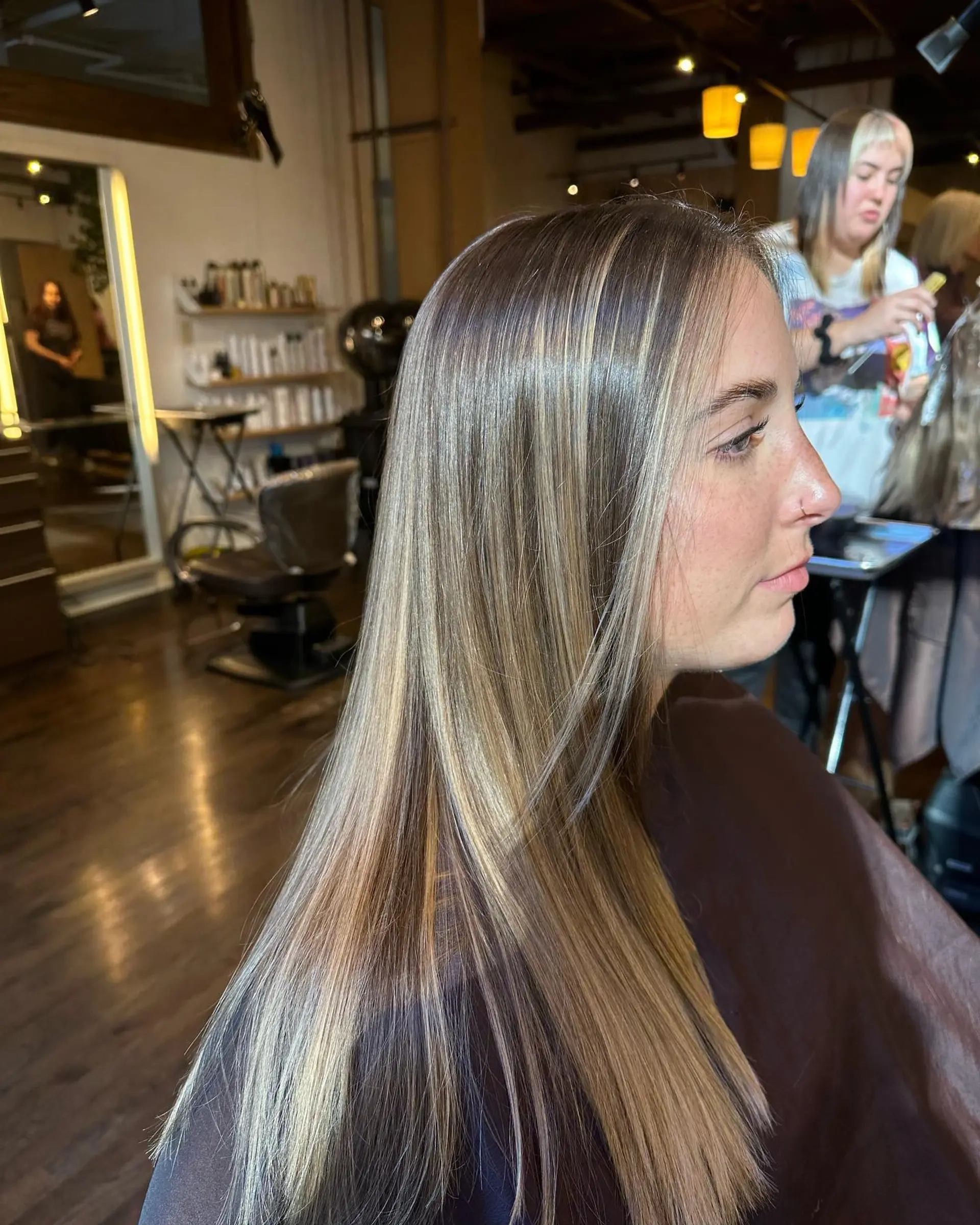 Long, straight hair with subtle face-framing layers and a warm honey blonde color. 2