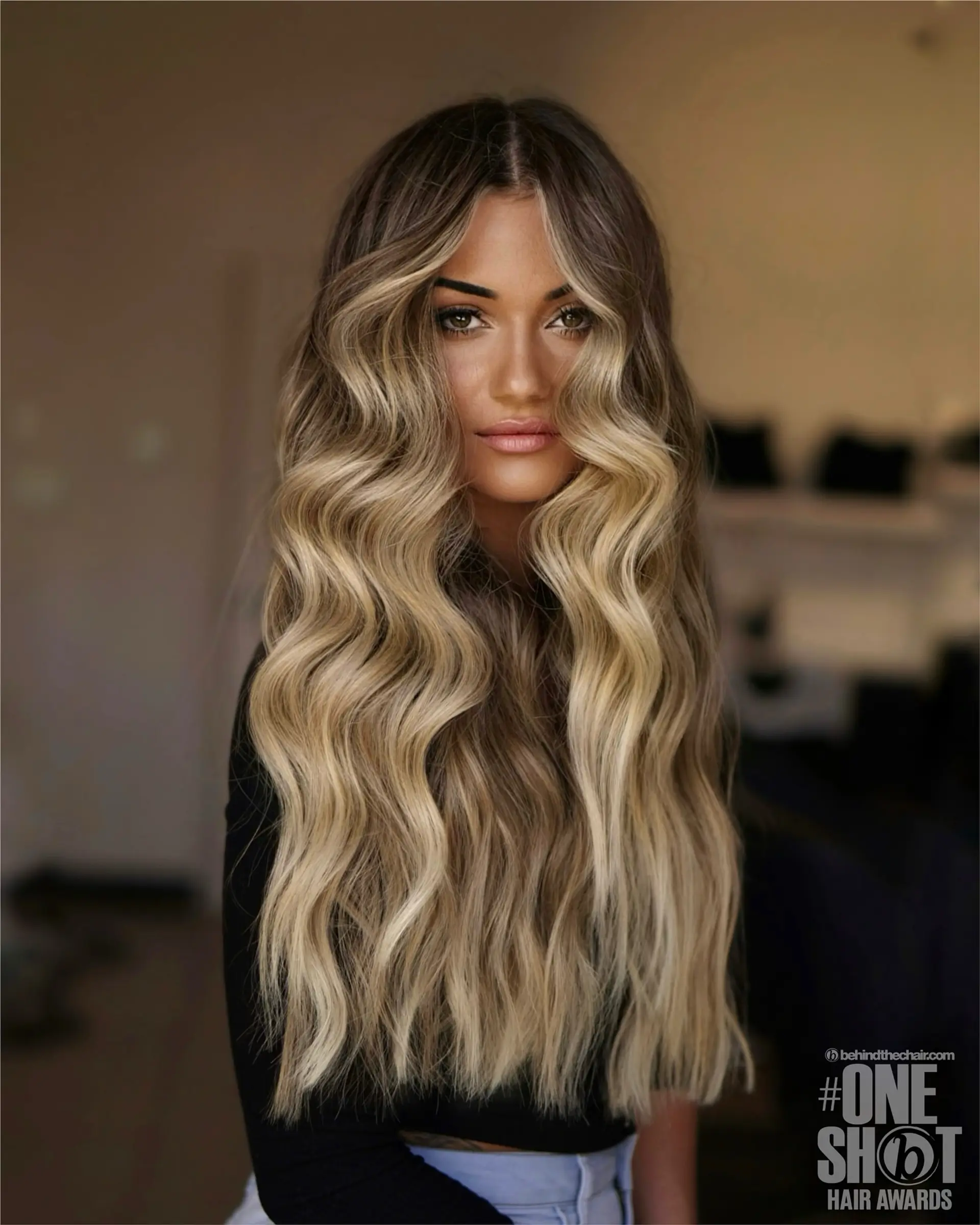 Extra-long lived-in blonde hair styled with cascading waves and bright face-framing highlights. 1